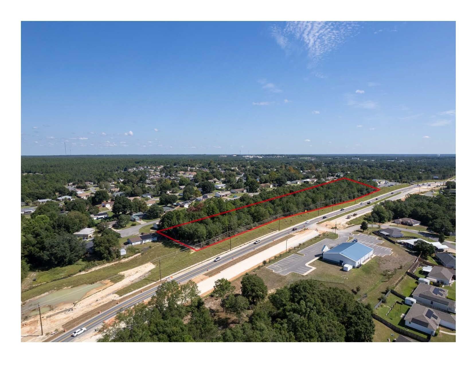 Wooded 4 acres of C-1 Commercial in the City Limits of Crestview.  Adjoins new Dollar General.   Ingress/Egress Easement thru Dollar General to access stop light intersection.  1,127 front feet on new four lane highway under construction and new Interstate 10 interchange to be constructed soon just west of site.  Present daily traffic count is 19,000 cars per day but will surely increase when four lane and new I-10 interchange is completed.  Property is deed restricted to some types of businesses and uses.