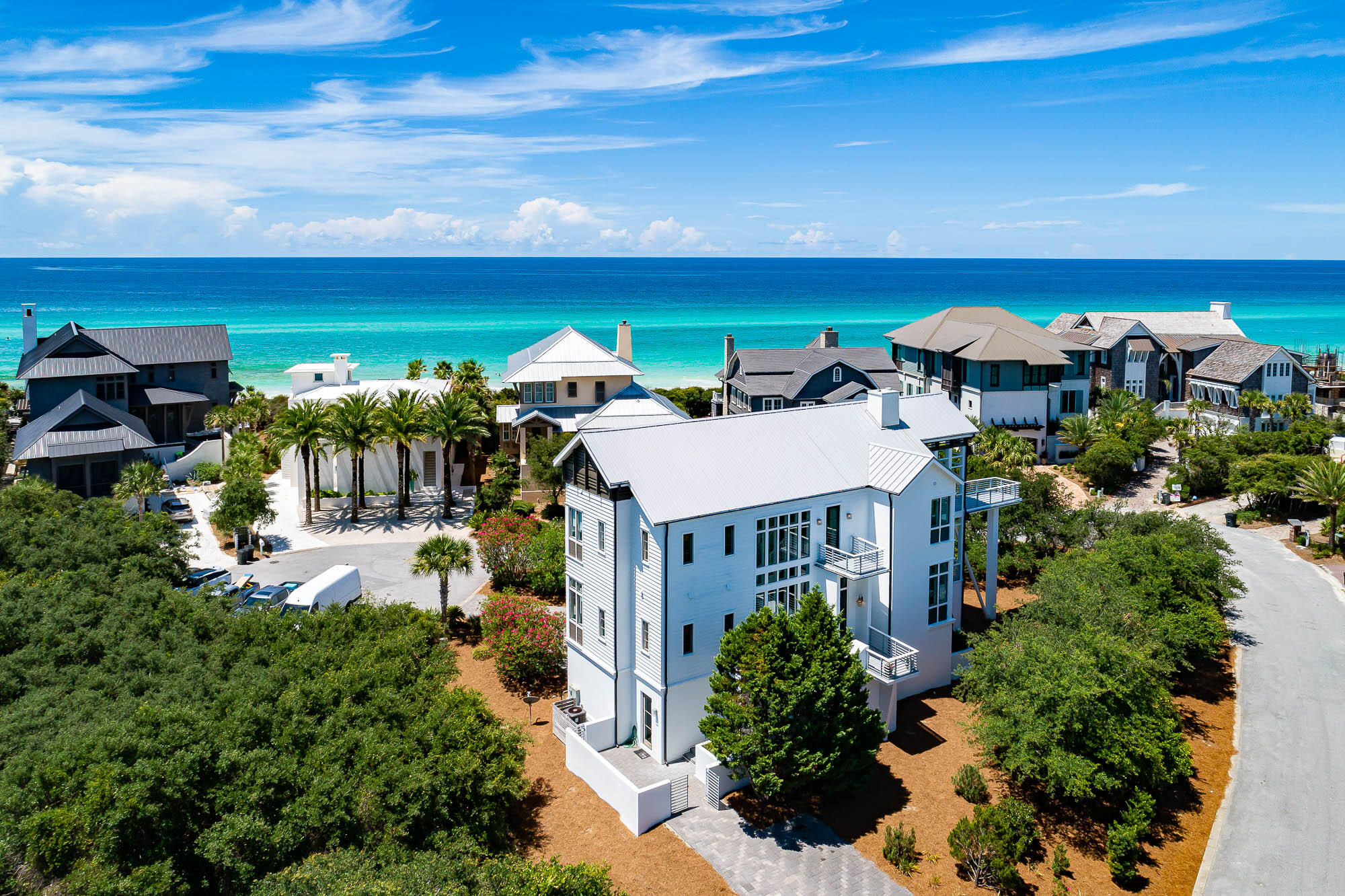 Poised south of 30A and one tier from the Gulf, 137 Camp Creek Point boasts a prominent and serene location and touts stunning Gulf and coastal dune lake views! With gated access, the ultra-private community of Camp Creek Point is comprised of only 16 home sites and perched on a magnificent point, offering a rare serenity and deeded beach access and lake access, both just steps from the home. Short-term rentals are restricted, further adding to a quiet coastal lifestyle. Architect Tom Christ designed this residence, which boasts a spacious and comfortable floor plan with ample natural light and multiple decks with stunning water vistas. Upon entering through the front door of the home, located on the second level, you are greeted by the impressive open living area, combining foye, living room, kitchen and dining, and the focal staircase that is graciously adorned by a wall of windows. A charming deck provides immediate outdoor access from the living area to lounge and take in breathtaking views of both the Gulf and Camp Creek Lake.  The hallway leads to the second level guest room, with en suite bathroom, and a half bathroom and a built-in desk with custom bookshelves are nicely situated in this hall. The main living areas marry the kitchen, dining and living areas for the ultimate gathering space, with wraparound windows for true coastal living wrapped in natural water views. Mounting to the third level, the landing gives way to the primary suite with en suite, an adjacent office room, and two guestrooms with en suites.  The primary suite has a large dedicated covered deck with outdoor seating positioned to enjoy majestic views of both the Gulf and the coastal dune lake. The two additional guest rooms also have access to a shared deck to take in the water views. A walk-in laundry room is situated on this third level for convenient access from all bedrooms. The lower ground level of the residence provides extra multi-functioning spaces and conveniences often lacking in beach homes, with a three-car garage, a large mudroom with built-in shelving, enclosed storage areas, and a spectacular flex room with a huge full bathroom equipped with two walk-in showers and direct access to the exterior.  Entering the mudroom foyer from the garage you are greeted by the stairs that lead directly up to the second level main living area. This coastal home embraces the coveted coastal elements of natural lights and view corridors with an abundance of windows and decks to create spaces enveloped in the sheer beauty of the surrounding views.  The east end location is uniquely quiet yet still benefits from the close proximity to the liveliness of 30A's east end restaurants and shops at the bustling neighboring communities of WaterSound, Alys Beach and Rosemary Beach. Discover unmatched seclusion of 137 Camp Creek Point Drive.