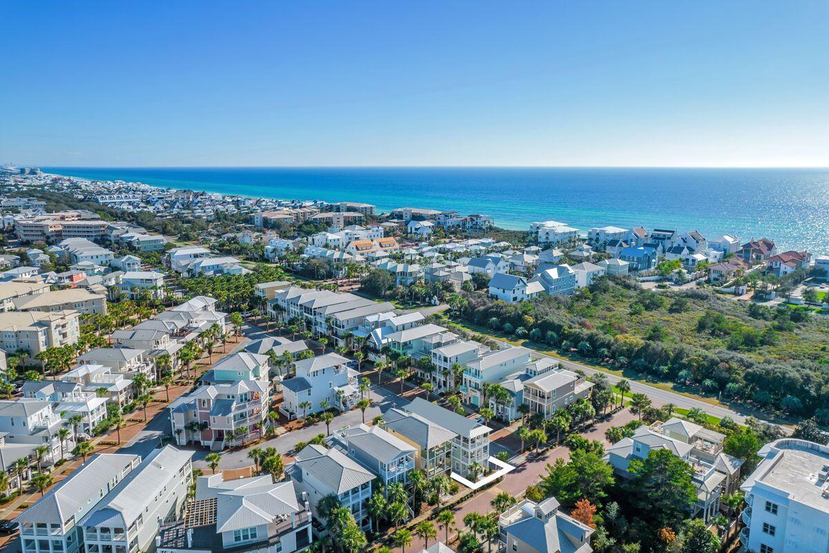 Under contract with 24-hour kickout clause. Home is complete!  New construction with gulf views one row off of Scenic Highway 30A are hallmarks of this Seacrest Beach retreat that features a gourmet kitchen and more than 1,300 square feet of porches just a short stroll to the 12,000-sq.-ft., community pool. This four-bed, four-bath home boasts more than 2,800 square feet of living space on three floors and deeded beach access. Designed to be used as a vacation rental or primary/secondary home, the open-concept floor plan provides room for entertaining and family gatherings. The gourmet kitchen will host one of two beverage coolers and ice machines, with additional appliances in the third-floor wet bar. Three A/C units and a tankless water heater have been added. Guests will enjoy large closets; 10-ft. ceilings; two master suites on the second and third floors; guest accommodations on the first and second floors; a second-floor laundry room; and, a spacious kitchen with gas oven and other high-end appliances as well as quartz countertops. All appliances convey with purchase. Finishes include designer tile, hardwood flooring throughout, four-panel Shaker-style solid core doors and designer lighting. The home's pièce de résistance is the 600-sq.-ft. covered third-floor porch with outdoor kitchen, with Naturecast cabinets (which are made for this environment and will last forever), and gulf views, a perfect place to wind down from a day in the sun. Upon completion, this home will comfortably sleep 14 or more. Seacrest Beach is a vacation favorite with palm-lined streets and nature trails in close proximity to the world-class dining and shopping that Scenic Highway 30A is known for. Buyer to verify all information and dimensions. Images shown are renderings. Actual finishes may vary. Buyer to verify all information and dimensions.