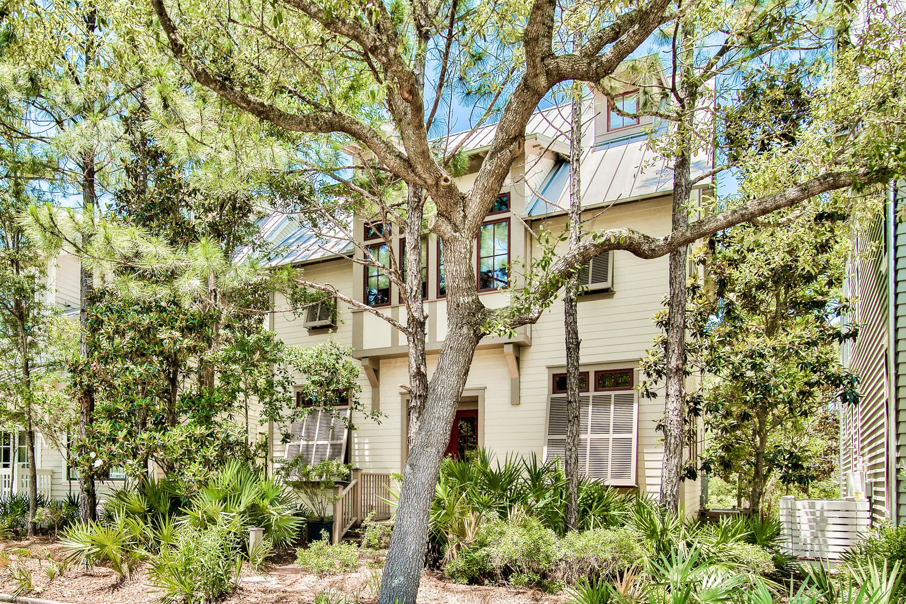 A rare opportunity to own a home on the south side of 30-A in WaterColor. 
Shops, Fish out of Water, the Beach Club & the Gulf are all close by. The first floor consists of two bedrooms, each with private baths. One even has a steam shower. Walk up to the second level and you enter the very open living, dining and kitchen areas. Exposed beams overhead, beautiful pine flooring and a fireplace add to the ambiance.  This  level opens to the hidden gem of the home - a large deck providing  glimpses of the Gulf and Western Lake through the pine trees in Grayton Beach State Park. The natural setting of the park combined with the Gulf breezes, sounds of the surf and the occasional deer sighting, and you have found your sanctuary. Proceed up a few steps from this level to an office, bedroom, a bunkroom for the kids and a bath. The top level is all master suite where you find a private sitting room with fireplace and wet bar, large bath with soaking tub & steam shower, 2 master closets and a private balcony overlooking the serenity of the state park. Home is selling furnished with a few exceptions which include some art