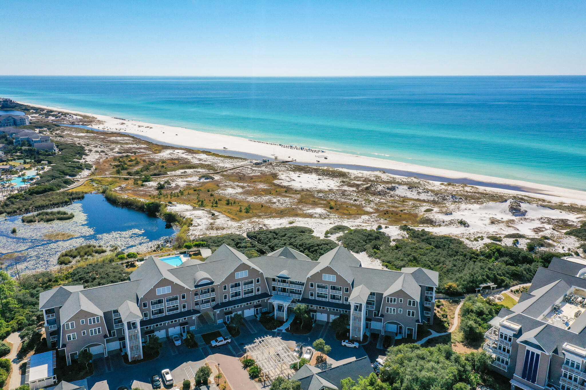 This stunning, recently remodeled and beautifully decorated coastal Nantucket style condo is 1 of only 25 condos. Architect, Graham Gund, designed and perfectly positioned it on the white sandy dunes and beaches of the Emerald Coast. This two story Gulf front condo lives large with a 1st floor single car garage, master suite with attached screened porch, a cozy bunk room and laundry room. The 2nd level has spacious living and dining areas leading to the most incredible covered porch offering stunning views. In addition there are 2 ensuite bedrooms and a office nook. Compass Pointe II captures so many details and special touches, such as antique gutters and shiplap accents and dedicated parking for golf carts and bikes.  Just a short stroll to the beach on your quaint boardwalk down to the crystal clear waters of the Gulf of Mexico.  Owners enjoy a private community pool and have the option of joining the exclusive Watersound Beach Club. Come see for yourself why Compass Point II is an excellent primary residence, vacation home or short term rental investment property!