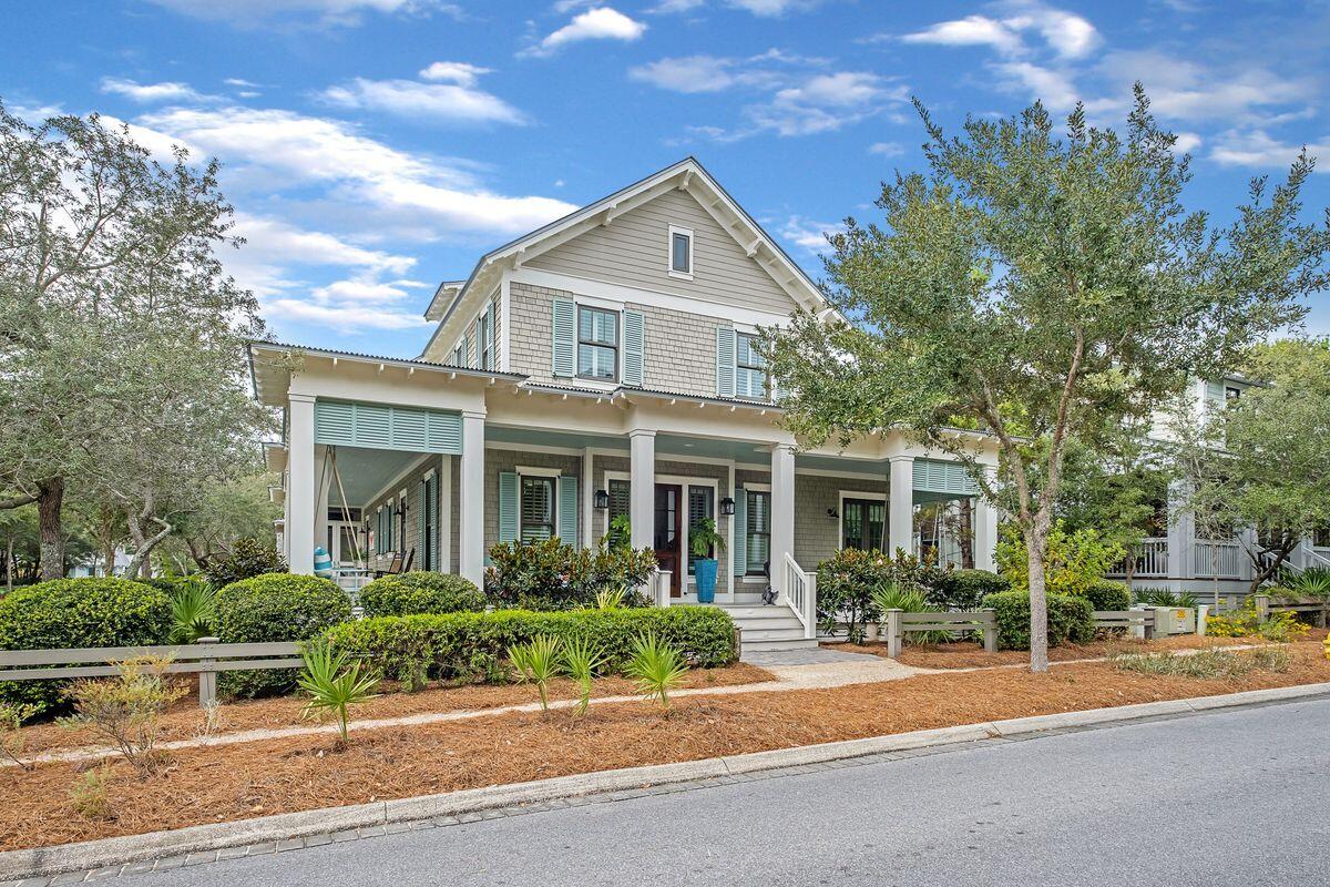 Impeccably maintained and positioned on a large corner lot just steps from Frog Pool, this WaterColor Phase III home is being sold by its original owners who spared no expense in its details. Ideal as a primary residence, vacation home or rental investment, this home offers instant curb appeal with a wraparound front porch and screened back porch, a carport readied for a carriage house (utilities have been pulled and plans will convey with sale) and a fenced backyard perfect for a pool. The open floor plan inside includes a chef-inspired kitchen with double islands, designer cabinetry, breakfast bar with seating for six, and stainless appliances including gas range, two dishwashers and an oversized refrigerator. It flows into a dining area with seating for 10. The custom design of the five-bed, four-bath home maximizes the use of the living space with no hallways, large bedrooms with generous storage options and a spacious laundry room. The first floor hosts two bedrooms including the owner's suite with private bath with three additional guest rooms on the second floor. The home's outdoor space sets it apart with a private patio, covered grilling station and sunning area. When you venture away from your home base, you'll be delighted by WaterColor's renowned amenities including pools, parks, Camp WaterColor and the luxurious Beach Club.