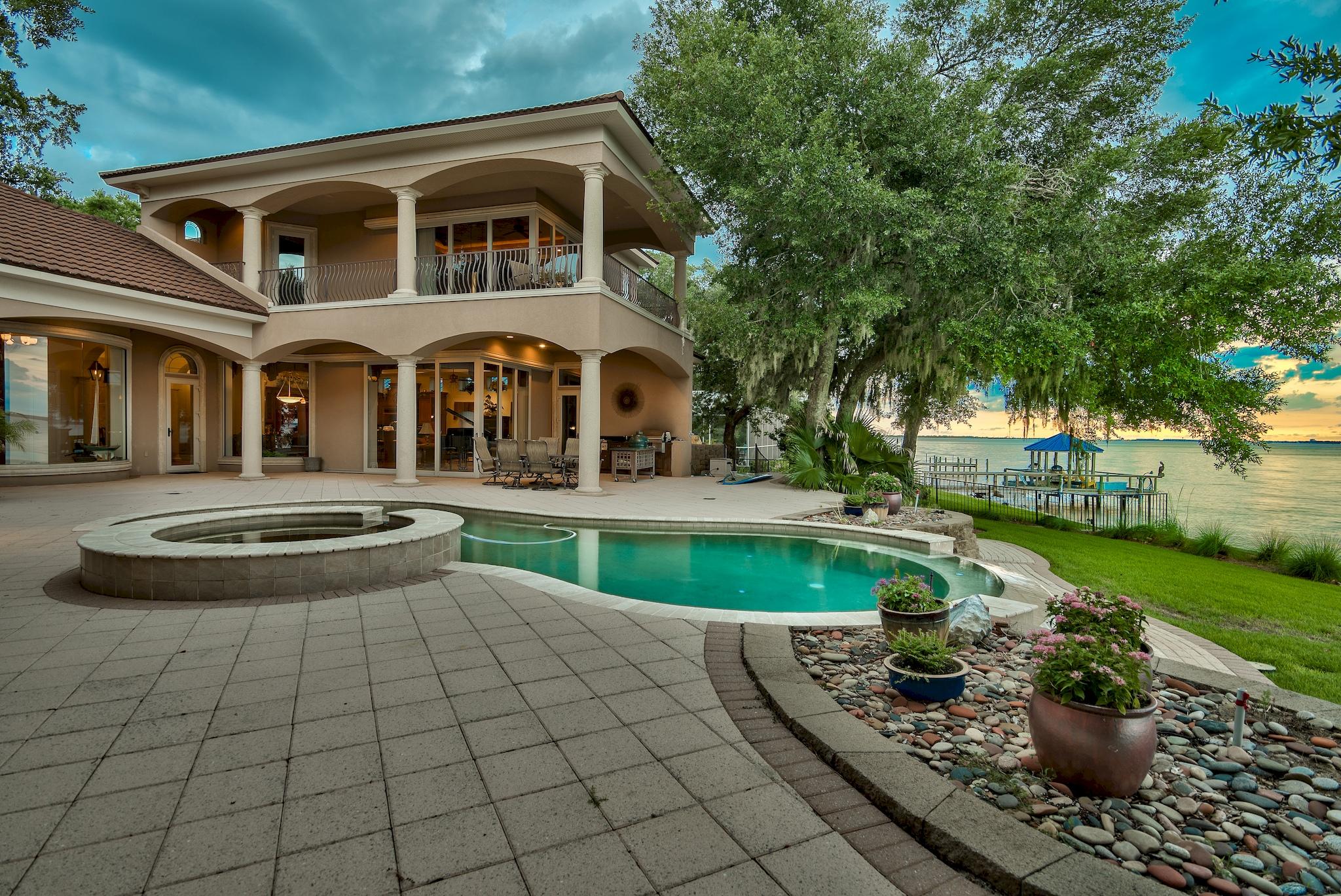 Stunning, ICF-constructed Mediterranean retreat on a massive 725-ft stretch of waterfront offers unmatched privacy and stately proportion. A long winding driveway, lined with shadowy live oaks, leads the way to a majestic 1.5-acre expanse located at the meeting point where the Choctawhatchee Bay joins Marler Bayou, offering prime water frontage and unique seascapes from two sides. This showpiece's timeless, luxurious interior appointments and opulent outdoor scaping are matched in exquisiteness only by the surrounding natural scenery. A spectacular, visually stirring bayfront oasis features an elevated deck with freeform infinity-edge pool and spa, covered seating, and well-appointed summer kitchen. Each dock - a swimming dock and a protected boat dock  offers deep-water access. Inside, this home is distinguished by its raised ceiling heights with triple-crown molding, decorative tray ceilings, solid Brazilian cherry wood floors,  wood custom built-ins, hand troweled walls, arched entryways, and a marble-floored foyer with an inlaid granite compass rose. Views of the Bay and Bayou are given center stage through glass doors that retreat and bow windows that gently curve out for expanded views. The gourmet kitchen features solid custom wood cabinets, granite countertops, double oven, paneled refrigerator, center island, large pantry with a free standing wine rack, and breakfast bar. The master suite, located on the main floor, is a comfortable retreat with morning kitchen, fireplace, sitting area, boutique-style closet, and sliding glass doors that lead to the pool area. A semicircle walk-in shower crowned by a soaring octagonal tray ceiling adds drama to the opulent master bath with custom cabinetry, travertine tile, soaking tub, granite counters, and linen closet. The 2nd-floor billiard room with wet bar, large balcony, game table, and full bath is perfect for entertaining. A murphy bed offers added sleeping space. A 3 ½-car garage and six additional parking spaces accommodate large crowds. This home includes a full study and an office, each with custom built-ins. Of note, the seawall runs along the entire length of the property. Furnishings convey in the sale with some exclusions. This stately waterfront home is just a short boat ride to the East Pass, Crab Island, and the Gulf of Mexico.
