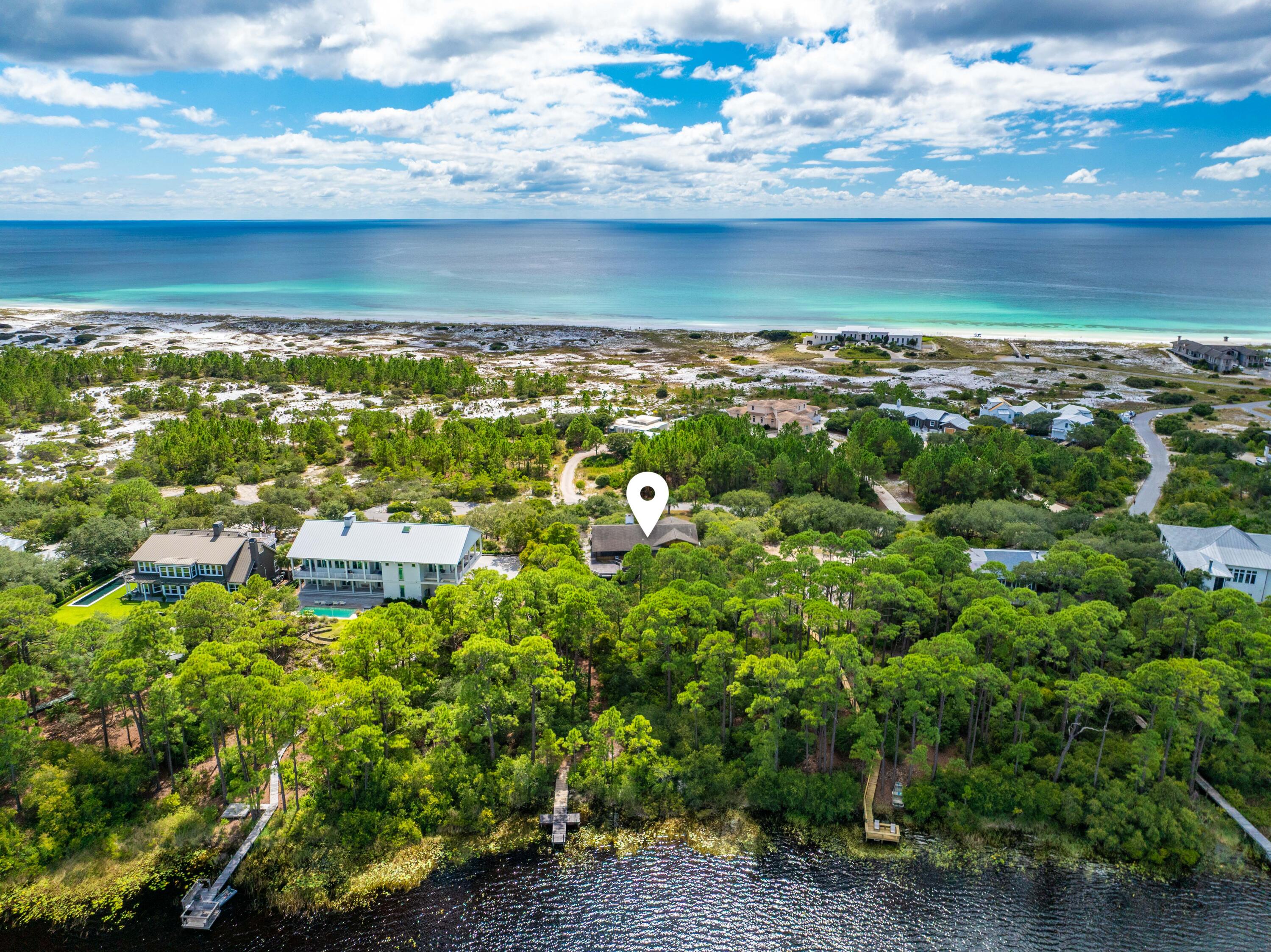 ***Accepting Back Up Offers***
Perched atop the dunes on an expansive 0.96-acre homesite, this property offers sweeping views of Fuller Lake, a pristine 60-acre coastal dune lake, along with glimpses of the Gulf.
This is the only home currently available in the exclusive, gated enclave of Four Mile Village, offering a truly rare chance to own in one of Walton County's most secluded communities.
The residence features 3 bedrooms, 2 baths, and generous living areas, all tucked among mature oak and pine trees for a sense of privacy and retreat. A private dock on Fuller Lake allows for kayaking, paddleboarding, and fishing, while residents also enjoy 2,200 feet of private beach access reserved exclusively for owners. Four Mile Village is bordered by the Coffeen Nature Preserve to the north and Tops'l Hill State Park to the east, creating a setting defined by natural beauty, tranquility, and protected surroundings. Hiking trails, historic landmarks, and coastal dune landscapes make this community one of the most unique along 30A.
Despite its serene and secluded feel, Four Mile Village offers the best of both worlds, just minutes from dining, boutique shopping, golf, tennis, entertainment, and healthcare.
Experience the unmatched lifestyle of Four Mile Village, where privacy, nature, and Gulf-front living come together in a way that simply cannot be duplicated.