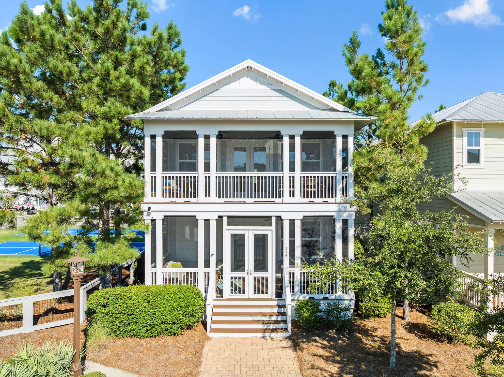 This spacious and beautifully appointed home features 4 bedrooms, a versatile loft, and a dedicated golf cart garage—perfect for convenient beachside transportation. This home offers  a peaceful natural setting.  Professionally decorated and fully furnished, the interior, showcases premium finishes throughout and is turnkey ready. Two generous screened porches provide inviting spaces for outdoor relaxation, overlooking lush greenery, the charming neighborhood, and the pickleball courts for endless fun. this home also makes a strong short-term rental, combining lifestyle appeal w/ excellent rental revenue!