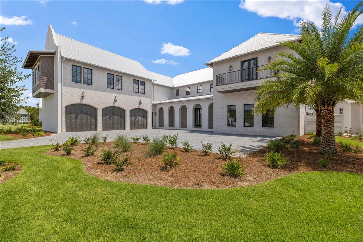 Welcome to 92 Quail Hollow Court, an extraordinary new construction estate in the exclusive gated community of Watersound Camp Creek. Thoughtfully designed in a timeless Craftsman style and spanning over 7,000 square feet, this two-story residence offers an unparalleled blend of sophistication, comfort, and resort-inspired living.

This exceptional home features 6 spacious bedrooms, 7 full baths, and 2 half baths, including a serene owner's suite on the main level and a private carriage house retreat. Elegant living spaces include a chef's kitchen, expansive living room, formal dining, hobby room, and a state-of-the-art home theater—with the added versatility of a theater or golf simulator room to suit your lifestyle. An elevator provides effortless access throughout the home,  enhancing both convenience and long-term livability. A dedicated office near the owner's suite offers exceptional flexibility and can easily be reimagined as a luxurious oversized walk-in closet or dressing room.

Set on 0.61 acres with over 100 feet of pond frontage, the property delivers tranquil views and seamless indoor-outdoor living. The private backyard oasis is complete with a heated pool, hot tub, summer kitchen, and multiple covered balconiesperfect for entertaining. Enjoy the added luxury of an infinity-edge spa, along with an additional flex/game space, ideal for a pool table, lounge, or secondary recreation area.

Premium details include a 3-car garage plus additional driveway parking, gas fireplace, stucco exterior with metal roof, and lush landscaping with irrigation. Modern comforts abound with natural gas, tankless water heaters, multiple A/C systems, and energy-efficient finishes.

As a resident of Watersound Camp Creek, enjoy world-class amenities including exclusive Beach Club access, championship golf, resort pools with lazy river, tennis and pickleball courts, wellness center, playgrounds, and more. Short-term rentals are not allowed, ensuring a private and peaceful residential enclave.

This masterpiece is move-in ready and perfectly positioned for those seeking luxury coastal living along Scenic 30A.