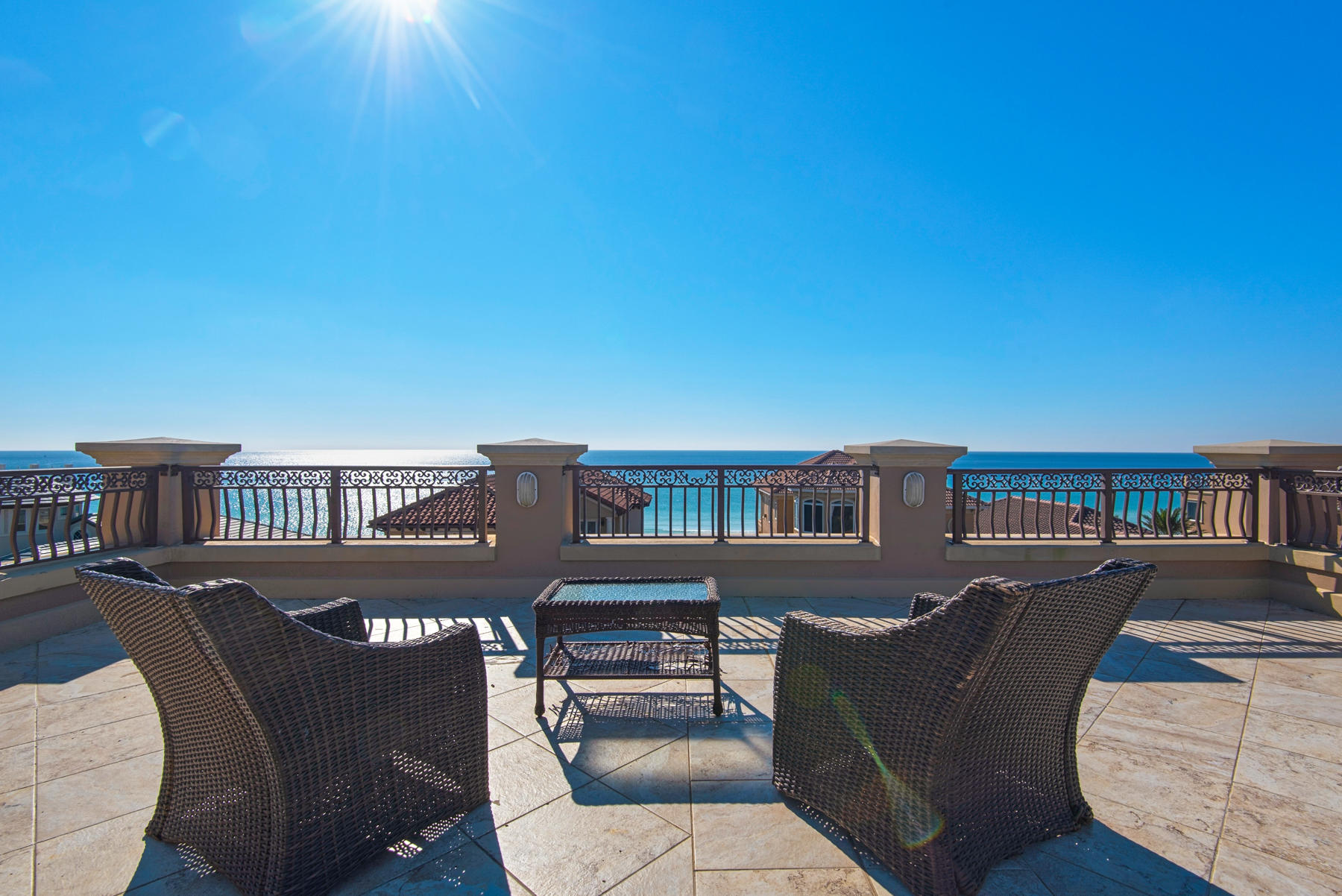 European splendor at the beach.  This exquisitely designed home boasts Destin's most beautiful roof top deck with 360 degree views of the Gulf and surrounding skyline.
Step inside the front foyer and you instantly realize that this is a home like no other.  It clearly is custom built with European influences that include coffered ceilings, travertine floors, unique chandeliers and imported features.   
The rooftop deck has a new TV, brand new gas grill. fridge, ice maker and sink. The Gulf views are nothing short of breathtaking.  From this 4th floor roof, you enter the house and pass the half bath on your way to the elevator or you can take the stone steps down to the 3rd floor where there is a guest bedroom with an ensuite bath and oversized closet.  There is a laundry room and of course the most magnificent Master Bedroom you can imagine.  Surround sound welcomes you into your retreat from family and guests.  Turn on the fireplace or step outside onto your private balcony to watch the ebb and flow of the waves of the Gulf of Mexico.  The Master Bath has a jacuzzi tub for two, separate shower, and dual vanities. On the second floor is where the magnificent kitchen captures your attention.  The oversized island can seat at least six and is also where the microwave, and wine cooler are discreetly tucked away.  High end appliances abound and even include an ice machine.  Turn your eyes to the south and enjoy another spectacular balcony facing the Gulf, or bring your meal outside and listen to the sounds of nature.  Adjacent to the kitchen is the dining area with seating for six at a formal table.  The living room is large enough to accommodate a stone sculpted fireplace, a regulation sized pool table and a full compliment of living room furniture. Adjacent to the kitchen is an office with large window and closet and can be easily converted to a bed or bunk room!
On the first floor there are two more bedrooms, one has double bunks and ensuite bath and a custom closet.  The other is a Master bedroom with another elegantly appointed bathroom. There is an additional laundry room with access to an outdoor shower for a refreshing "rinse off" after you return from your 50 steps walk from the private entrance to the beach. There is a concept animation for a small private pool (see Documents) or you can walk around the corner to the community pool.

This home is being sold fully furnished (excluding contents of owner's closet and rental linens.)