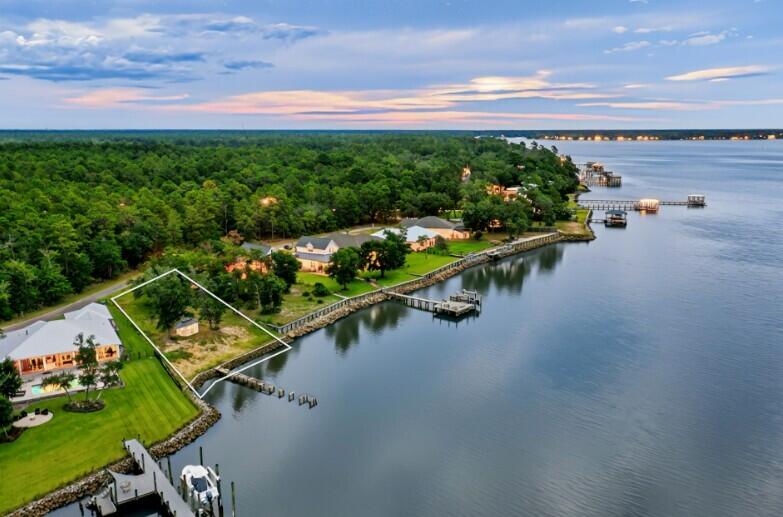 AMAZING VIEWS from one of Freeport's best-kept secrets— waterfront lot on 115 feet nestled along the deep waters of the Choctawhatchee Bay on Red Barn Road. It is an exceptional site for boating enthusiasts and those who seek unobstructed views of pristine sunrises and sunsets over the water. This stunning parcel is a hidden gem among luxury homes, offering you the ideal canvas to create a waterfront retreat with endless boating possibilities.The seller has upgraded the retaining wall, ensuring lasting shoreline protection and adding significant value to the property. Red Barn Road is renowned for its peaceful atmosphere, offering convenient access to the Emerald Coast beaches and all that the Florida Panhandle has to offer. City Water and electric, City Sewer is available. . Robola Bluffs has recorded Restrictive Covenants but there is no HOA in effect at the present time - No HOA fees, and no build time.