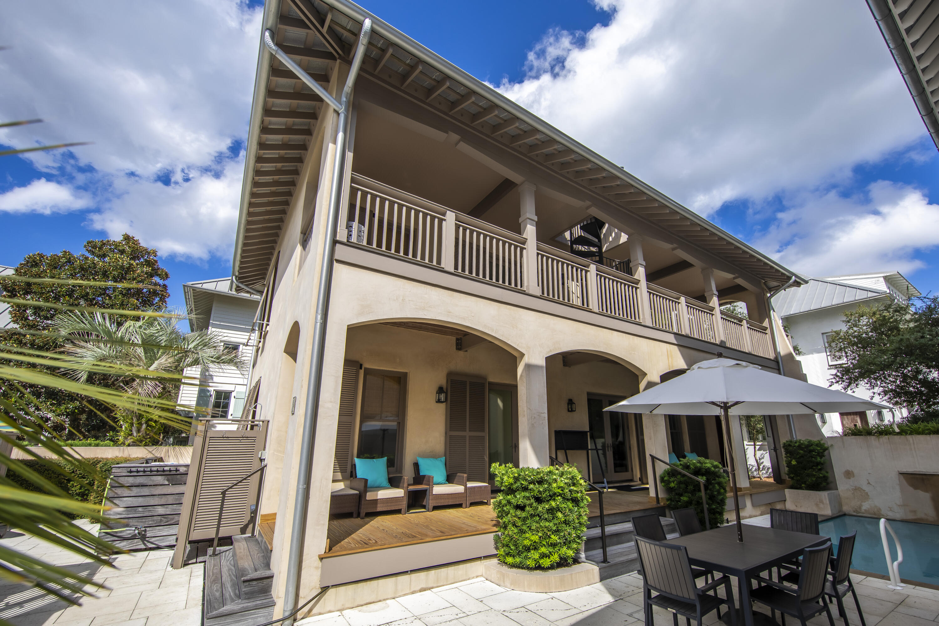 Discover your serene retreat in the heart of Rosemary Beach. This stunning 4 bedroom, 4.5 bath home combines resort-style amenities with the charm and beauty of coastal living. Nestled just South of 30A, step outside your courtyard door and take the boardwalk directly to the beach! Expansive porches that stretch the full length of the home overlook your private outdoor sanctuary, complete with a pool, waterfall and a spa! The resort style courtyard is perfect for gatherings, featuring a fully equipped summer kitchen with a natural gas grill, refrigerator, and sink. A convenient main level bedroom offers flexibility for guests, family, or personal use, enhancing both comfort and accessibility. 3 additional bedrooms on the second level, all with en-suite baths, offer your guests privacy and comfort. Concrete block construction is finished with smooth coat stucco for easy maintenance. The large lot presents affords the valuable opportunity for an addition or a future carriage house. Set up your tour of this private resort today, South of 30A in Rosemary Beach.
