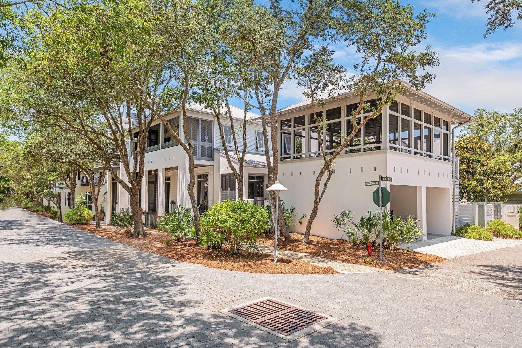 NOW PRICED BELOW $3M!! This recently renovated home, previously showcased in Coastal Living magazine, epitomizes coastal elegance and functionality. Crafted by Tim McNamara, it seamlessly blends comfort with sophistication, boasting over 1,500 square feet of exquisite exterior living space. Nestled on a large corner lot facing an arbor-inspired pocket park, it offers a serene retreat. The open floor plan, complemented by designer furnishings and details offers a definite ''wow'' factor. Front and side porches, accessible through French doors, invite an abundance of natural light.  Dubbed Spellbound Cottage, this abode features SONOS streaming music throughout and four bedrooms, each with private bathrooms and porches. A corner look out tower offers panoramic views, while a two-car carport with a 484 sqft screened porch above, adds versatility and the potential to be converted into a guest cottage.