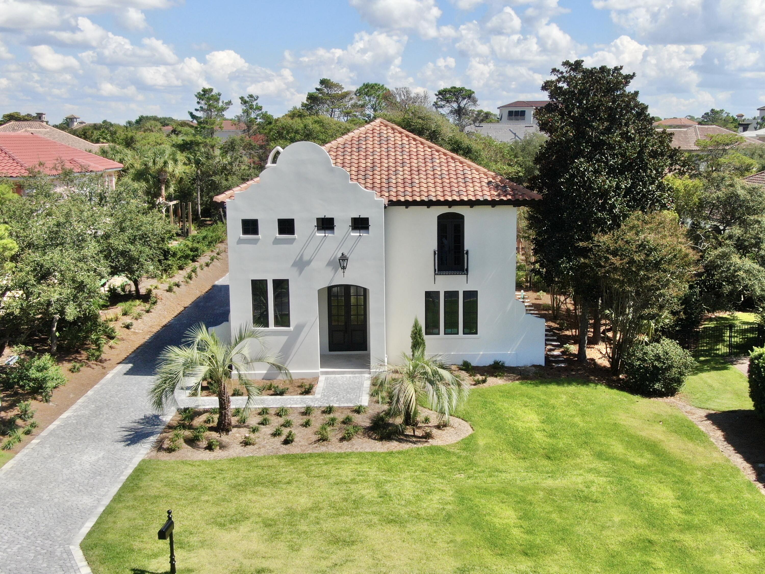 Construction COMPLETED OCTOBER 21st!! Available for IMMEDIATE OCCUPANCY! A one-of-a-kind, luxury residence - nestled securely within the GATED, rental-restricted community of BellaMar at Gulf Place and situated just steps from its DEEDED BEACH ACCESS - offers a golden opportunity to start living your best beach life! Established along a prime stretch of sought-after 30A, BellaMar provides privacy in an ideal location, neighboring Santa Rosa Golf Course, and set across from Santa Rosa Golf and Beach Club. Enjoy an easy stroll to local boutiques and eateries of nearby Gulf Place and quick access to the bike pathways along exciting 30A! This extraordinary property has undergone a total home makeover and now offers 4,112 sq. ft. of refined living space thoughtfully designed and built by Blue Vista Builders, Inc. Positioned on an expansive .38 acre lot, this exceptional 5 BEDROOM, 5.5 BATH compound incorporates a MAIN HOUSE and a CARRIAGE HOUSE with 2-CAR GARAGE, connected by a lovely COURTYARD with PRIVATE POOL. High quality details inside and out include: shellstone and wood flooring; rounded-corner walls, windows and doorways; arched entryways; wood beams; custom cabinetry; professional grade, stainless appliances and quartz counters in the kitchen; WALK-IN CLOSETS with built-in storage; FIRST AND SECOND FLOOR LAUNDRY stations; cobblestone pavers; gas lanterns; multiple porches and balconies; and luxury finishes to complement the home.
The MAIN HOME features 4 bedrooms and 4.5 baths, with the MASTER SUITE on the FIRST LEVEL. The inviting front entrance showcases an impressive foyer and stairwell with soaring 21 ft. ceilings, wood beams, a view of the second floor foyer balcony, and windows welcoming natural light. An arched entry leads to an open concept of dining, kitchen, and living spaces to keep gatherings connected. The kitchen promotes a user-friendly workspace with niceties the chef and entertainer will appreciate. It features a large quartz island, Subzero and GE Monogram appliances, custom cabinetry with pull-outs, and built-in hutch complete with wet bar and ice maker. An alluring living room boasts 21 ft. ceilings complemented by wood beams, a view of the second floor loft balcony, a gas fireplace, and French doors which open to a peaceful courtyard and pool with sun shelf feature. A powder room is conveniently located off the kitchen, living and dining area. The spacious master suite has plentiful room for a sitting area, French doors which open to the courtyard/pool, large HIS & HER WALK-IN CLOSETS with built-ins, and built-in laundry station. Tie it up with a well appointed bath highlighting a fabulous soaking tub, oversized shower, and dual separated vanities with custom makeup counter and storage cabinetry.
The second level contains 3 sizable bedrooms, each having their own unique features, ample closets with built-ins, and EN SUITE BATHS with walk-in showers. Additionally, there is an irresistible BONUS/LOFT - suitable for multiple purposes - with balcony overlooking the amazing living room, plus a second built-in laundry station. Upper bedroom #1 features a Juliet balcony offering a postcard view of a well maintained beach community. Upper bedroom #2 includes a built-in wardrobe closet, dressing area, and Hollywood-style bath, accessible two ways: from the bedroom and from the bonus/loft area via pocket doors. Upper bedroom #3 is enhanced by French doors leading to its own covered porch overlooking the courtyard/pool. This generous bedroom also features a sitting area, and could be considered a SECOND MASTER SUITE, with double vanity, walk-in closet, and oversized shower.
The delightful carriage house includes a 2-car garage with storage closet and a third laundry station - for the convenience of beach/pool towels and carriage house guests. Anyone will feel special in the accommodating second floor suite, featuring a bedroom-living room combination, French doors to its own covered porch overlooking the central courtyard/pool, plus kitchenette, full bath with double vanity, and walk-in shower.
With so many desirable features, don't miss your chance to make this rewarding custom home your own!