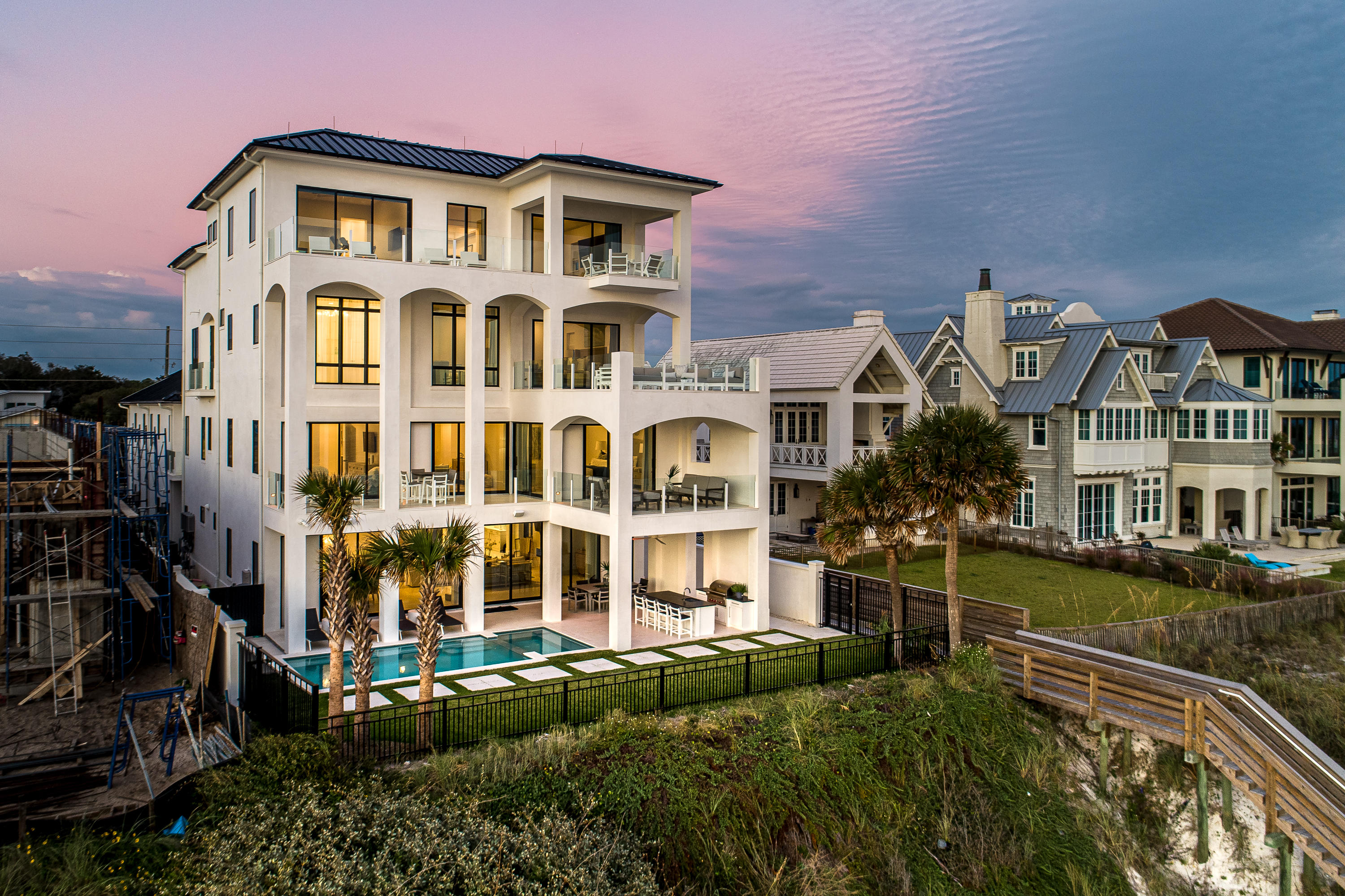 Nestled in the heart of Seagrove Beach, this recently completed, four-story Gulf-front masterpiece redefines luxury coastal living. Spanning approximately 9,981 square feet, this extraordinary retreat offers seven spacious bedrooms, nine lavish bathrooms, and a custom five-car garage, all designed to indulge the senses and celebrate the unmatched beauty of the Emerald Coast.

Positioned to capture breathtaking waterfront views from every angle, the home's top-floor vantage point provides sweeping, panoramic vistas stretching from Destin to Panama City Beach. The epitome of elegance and sophistication, this residence was meticulously crafted with enduring quality in mind. Its floor-to-ceiling concrete construction ensures exceptional durability and energy efficiency, a rare combination in a beachfront property.

Upon entering the first level, you're greeted by an expansive, open-concept living space bathed in natural light, courtesy of an impressive wall of windows that frame the stunning Gulf of Mexico. The seamless integration of floor-to-ceiling glass doors invites you to step onto the rear deck, where the sights and sounds of the ocean come alive. This seamless indoor/outdoor flow leads to the pristine Gulf-front swimming pool, where you can enjoy private sun-soaked moments just steps from the emerald waters.

From the high-end finishes to the unbeatable location, this home offers an unrivaled lifestyle experience that brings both beauty and functionality to the forefront of beachfront living. Whether you're gazing out at the glittering horizon from the comfort of your living room or enjoying direct access to the Gulf, every detail of this remarkable retreat is designed to immerse you in the coastal charm of Seagrove Beach.