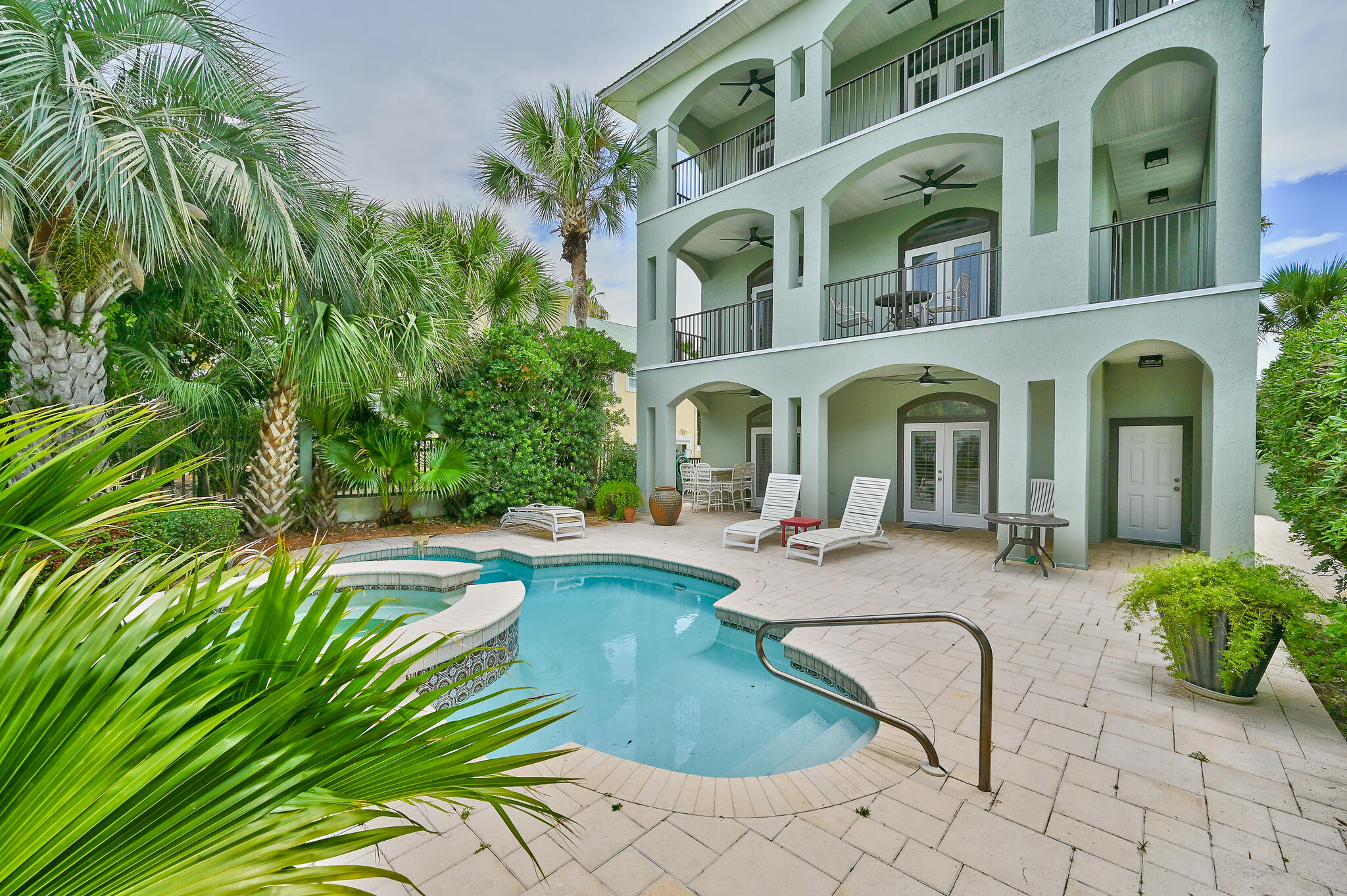 Location, Location, Location! Wonderful home south of Scenic 30A, close to the shops and restaurants of Gulf Place. With 5 bedrooms, 5 baths plus a small bunkroom, this special home is a great rental investment/2nd home!  Gulf views! 
Large pool with mature palms and landscaping. 2nd level master suite and 2 car garage were added in 2009. Another spacious master suite on 3rd floor.  Elevator services all 3 levels. All new doors and windows throughout in 2022 (except entry door and fan lights.)   
Walk to the public beach access just steps away on S. Spooky Lane! Being sold As-Is.  Easy show!!