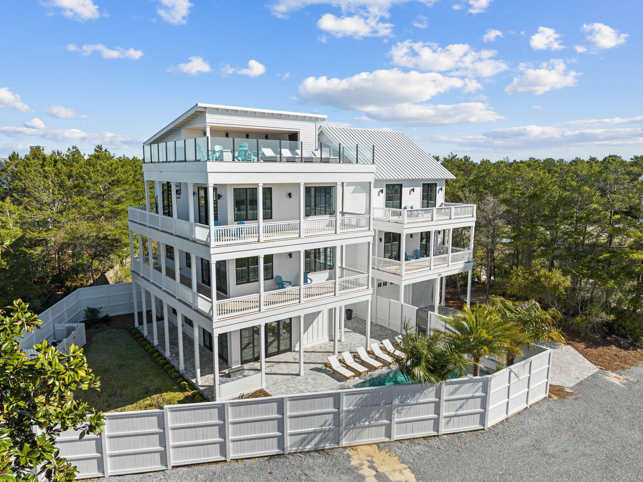 11 DAY BIDDING OPPORTUNITY. SUBMIT YOUR HIGHEST AND BEST BY 7/23/24. Presenting a stunning, newly built 8-bedroom, 8.5-bathroom coastal retreat with captivating views. This custom beachfront property is a true masterpiece, ideally positioned between Highway 98 and the picturesque Highway 30A... just minutes away from shopping, dining and the outstanding Emerald Coast beaches. A breathtaking facade welcomes you with a sharp and elegant all white exterior with black windows. There is a natural flow to the interior of the home along with beautiful architectural lines, vaulted ceilings and stunning finishes including Quartz, oyster color washed Fire Rock tile, luxury finishes and custom lighting throughout. Open living spaces with floor to ceiling views out to the Coastal Dune Lake offers quiet serenity.
Equipped with a gourmet chef's kitchen with top of the line appliances and finishes, walk-in pantry, custom hood and cabinets. Glass doors throughout the house provide seamless access points to the exterior, maximizing indoor/outdoor living. Additional features include elevator, office space, two laundry rooms, and exercise room. Wake up to breathtaking views of the water as the Master Suite with private balcony, vaulted ceilings and tall windows brings the beautiful outdoors inside. The fourth floor exudes relaxation and luxury with a partially covered deck, wet bar and tv - overlooking stunning views of the Gulf perfect for watching the sunset. Outdoors you will find a large fenced in property with sparkling private swimming pool.