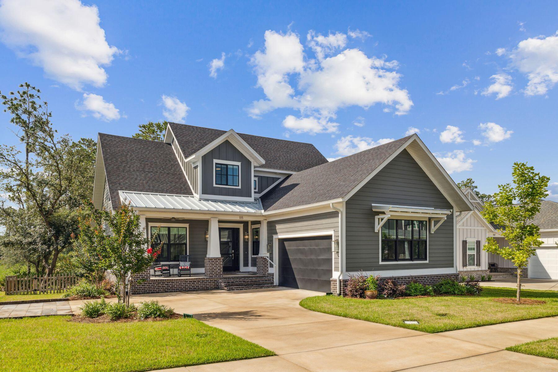 Welcome to this stunning family home in the highly sought-after Deer Moss Creek neighborhood, beautifully nestled against protected green space. Built in 2022 by the esteemed Janssen Construction, this thoughtfully designed residence blends traditional charm with industrial flair.
As you approach, three shallow brick steps lead you up to a covered front porch supported by tapered porch posts an inviting space to enjoy peaceful outdoor moments. Step inside and be greeted by an abundance of natural light pouring through large windows, showcasing luxury plank flooring and a cozy brick fireplace, complemented by a gas wall fire that serves as a striking focal point in the living room. The dining area, with dual-aspect windows offering delightful neighborhood views, is ideal for family meals or entertaining guests. The kitchen stands out with its avant-garde style, highlighted by a bold red 36" SMEG gas range that contrasts beautifully with minimalist gray cabinetry. The veined black marble countertops and central island with seating encourage casual conversation while enjoying breakfast. A dedicated laundry room keeps everyday essentials tucked away, and a charming office space is discreetly located behind an antique door for added character.
The first-floor master suite is a true retreat, offering three-directional windows framing tranquil wooded views. The airy cathedral ceiling, adorned with black beams, adds architectural interest. French doors lead into the spacious walk-in closet and the luxurious ensuite bathroom, featuring twin vanities and an oversized glass shower.
A screened porch off the living area invites you to step outside and relax while overlooking the generous, fenced yardperfect for children and pets. There's even ample space to add a pool in the future. The custom elevator provides easy access to the second floor, where an open loft area with a built-in daybed and wet bar offers a great space for relaxation or entertainment. The spacious family room currently serves as a bonus sitting area, ideal for cozy movie nights.
The second floor also includes three tastefully decorated bedrooms, providing ample room for family and guests. With three full baths and two half baths, there's plenty of private space for everyone.
Additional features include a two-car garage, a wide driveway, and access to a range of community amenities, including a clubhouse, swimming pool, basketball court, and playground. Deer Moss Trail is perfect for biking, running, and exploring the scenic surroundings of the babbling creek.
This home is a perfect blend of luxury, comfort, and functionalityschedule a showing today and experience the beauty of Deer Moss Creek!