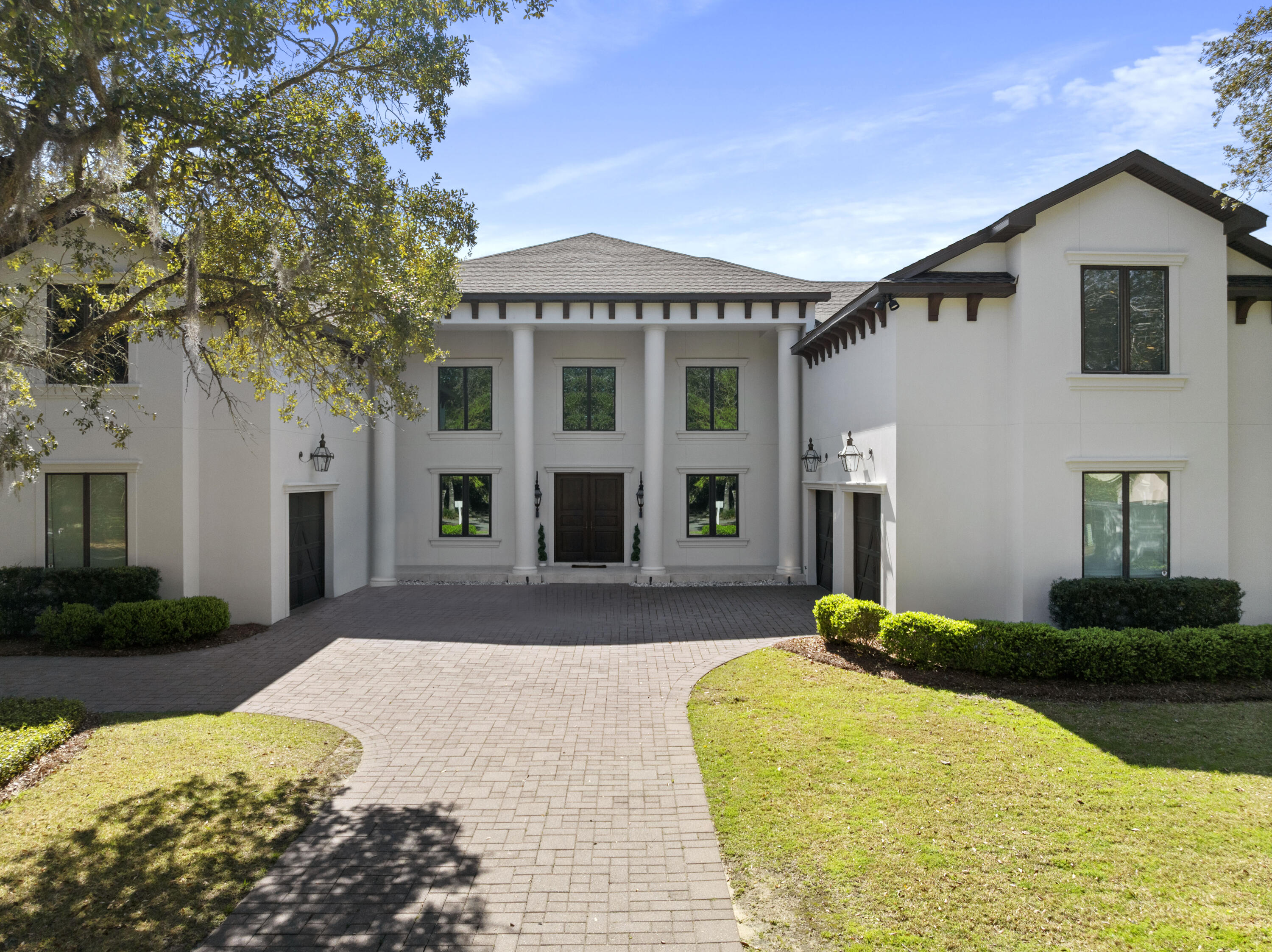 Back on the market after a little 2025 glow-up—and honey, she's not just resting, she's rejuvenated! With a brand-new roof, fresh exterior paint (including the front and garage doors), a new Navien tankless water heater, and all-new smoke and carbon monoxide detectors, this elegant Italian villa in Olde Plantation Place within Kelly Plantation is more than ready to impress.
Perfectly tucked into a peaceful and private cul-de-sac, this spacious stunner is ideal for entertaining or housing a crowd, offering 6 bedrooms, 5 full baths, and 2 half baths. From the moment you pull up, the Bevolo copper gas lanterns and grand white columns set the tone for timeless style.

Inside, soaring trey ceilings, a striking floating staircase, and a sunlit breezeway welcome you in. The main suite is a private retreat with two walk-in closets, a luxurious Kohler Hydromassage soaking tub, multi-function shower, double vanities, heated floors, private laundry, and automated window coverings (including the lanai door). On the opposite wing, guests will enjoy a full suite and additional bedroom with a shared half bath.
Upstairs, you'll find two more guest rooms, a game/media area, secondary laundry room, conditioned storage, and a spacious private office (or 6th bedroom!)with plumbing already roughed in for a future en-suite bath.
Step outside to your poolside paradise: a heated pool, hot tub, elevated gas fire pit, outdoor kitchen, TV, and a fully screened enclosureall designed for year-round enjoyment. And yes, the Generac generator, gas pool heater, and tankless water heater have your back no matter the season.
Extras? Of course. A fully fenced backyard (plus extra yard space beyond the fence), and a front and rear electric pet fence for added peace of mind.
Kelly Plantation offers resort-style living with golf, tennis, pickleball, playgrounds, dog parks, equestrian center, trails, parks, a resident-only club and grill, and more. All just minutes from Publix, Lowe's, Whole Foods, Destin Commons, and Lulu's.

Come see this beauty that's all dressed up and ready to meet her forever family!
