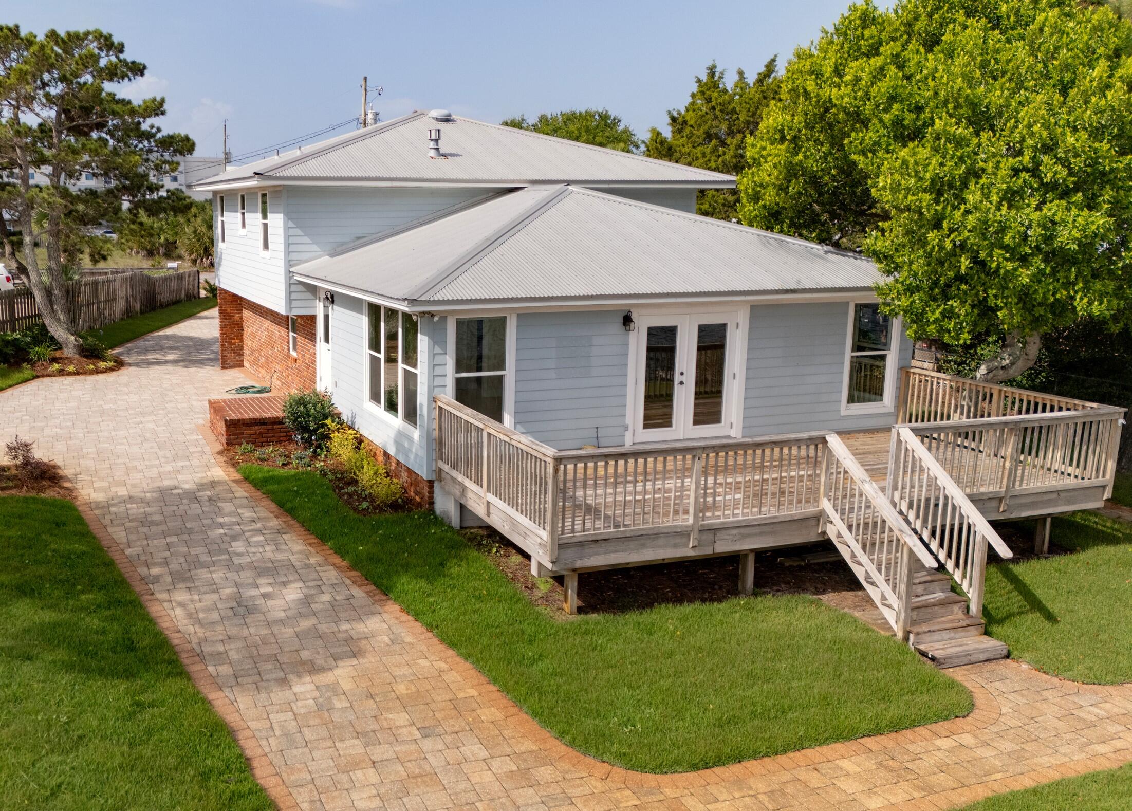 Here is the unicorn waterfront property you've been looking for! On beautiful Okaloosa Island, this 3-bedroom, 3-bath home overlooks the serene Intracoastal just across from the Landing. With 102 feet of waterfront, this property is uniquely situated to offer 180 degrees of panaromic sunrise and sunset views. The deep water dock is a boater's dream, with 4 wet slips, covered aluminum QAB boat lift system for up to 20,000 pounds, and a 200-amp electrical service. Just a short walk to the famous sugar-sand island beaches, this home has everything you're looking for in waterfront living. Golf carts welcome!


The beautifully renovated interior offers an expansive kitchen and living area with high impact hurricane windows and double French doors (also hurricane rated) for plenty of natural light. 

Quartzite countertops, stainless steel appliances, and custom wood cabinets provide the Chef with a convenient, modern kitchen, including a 5-burner range and Bosch dishwasher. Enjoy those spectacular views without leaving the kitchen! The oversized primary suite has his and her closets and an updated bathroom with quartzite, lovely wood cabinets, hexagonal tile floors, and new light fixtures. All 3 bedrooms have gorgeous engineered hardwood flooring. 

Oversized garage has plenty of room for kayaks, paddleboards, and other water toys in addition to your vehicle. The third bathroom is just off the garage and is easily accessible from the living space, while also providing convenient access from outdoor activities. A hurricane-rated garage door has also been installed. 

With one of the longest waterfront footages on the Island, the exterior is just as lovely as the interior, with brand new landscaping and sod and a firepit overlooking the water. A fence with gated access provides extra peace of mind. The dock will accommodate your 100-foot yacht or several smaller water toys - or anything in between. A deck overlooking the water is perfect for entertaining. The striking paver system provides plenty of parking and is rated for high-weight commercial loads.