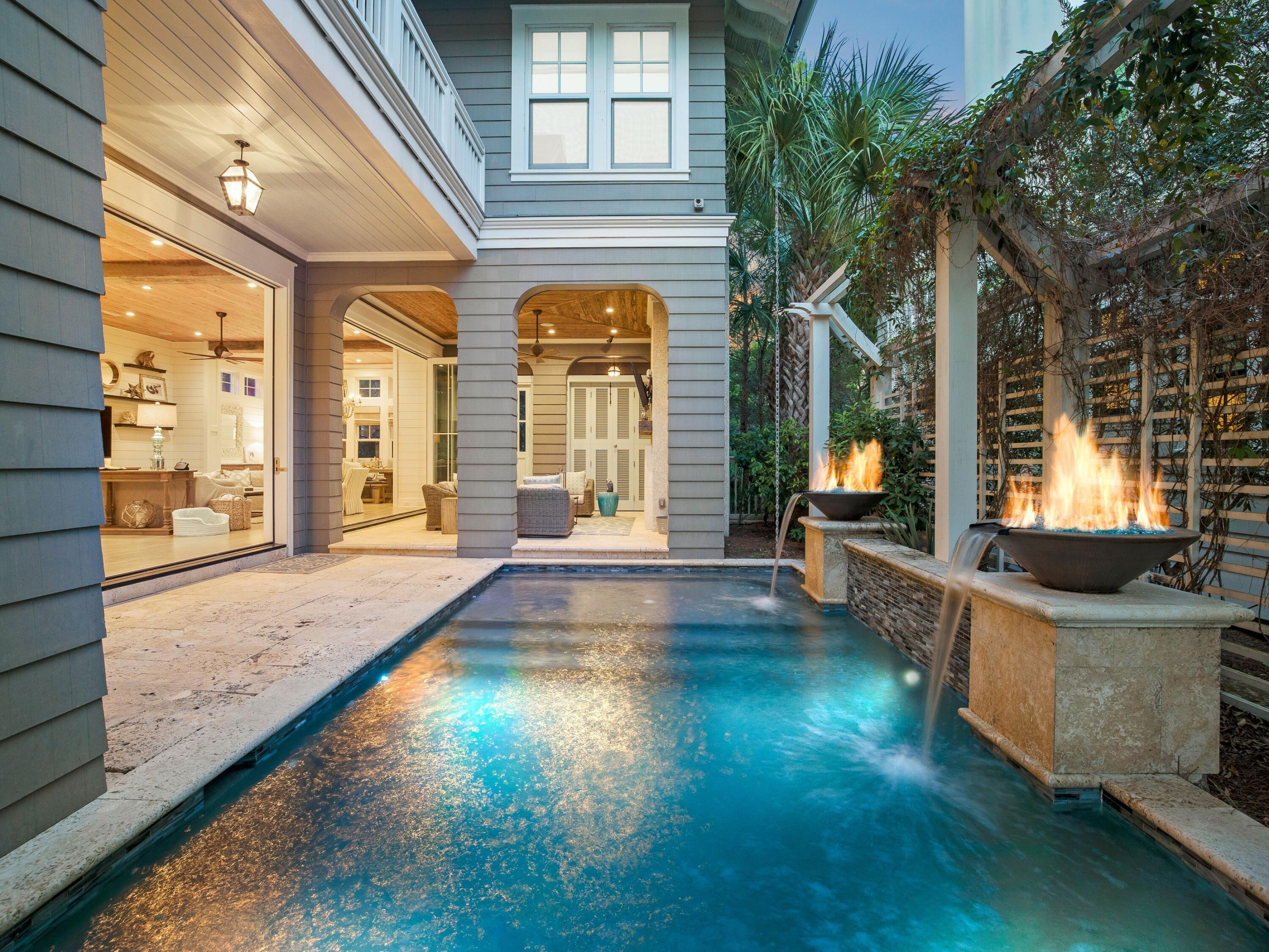 A classic coastal style is embraced in every detail of this custom WaterSound Beach residence. This large five bedroom can accommodate upwards of twenty guests with its unique multi-level bunk area. 34 Tidepool Lane borders peaceful puttering park, has never been rented and is immaculately maintained. Designed by Greg Jazayeri with interior design by Nest Dcor, a stunning Nanawall system offers cohesive interior dining and living spaces. The loggia and covered outdoor living area that lead to the 12'x24' heated pool with fountain and fire features. Inside the home, you will find an accommodating open concept plan with airy 11.5' ceilings throughout the first floor, a fully-equipped kitchen with Carrera gold marble, Thermador appliances, an expansive island, and an elevator. A spacious living room and a dining room with a built-in wine bar and custom storage are just off the kitchen. On the second story, find a luxe master suite with a fireplace, separate sitting area, a private porch overlooking the park and vaulted ceilings. The master bathroom offers a spa-like atmosphere with vaulted ceilings, Carrera gold marble accents and a morning coffee bar. Two guest bedrooms with ensuite bathrooms are also on the second floor along with a common sitting area. The third floor offers a bunk room, full bathroom and an additional bedroom. Special features of the home include a SMART system with alarm, HVAC, lighting and security camera controlled directly from your mobile device, multiple porches, walk-in closets in every bedroom, a professionally landscaped yard with mature trees, designer lighting throughout, custom furnishings and much more.
This gated community of WaterSound Beach is located south of Scenic 30A and offers homeowners a rare sense of seclusion with easy access to area activities. Other amenities include swimming pools, a puttering park, community green spaces, fitness center and private boardwalks to a spectacular coastline and majestic sand dunes. The optional private Watersound Beach Club is an easy golf cart ride to large pools and beach front dining.