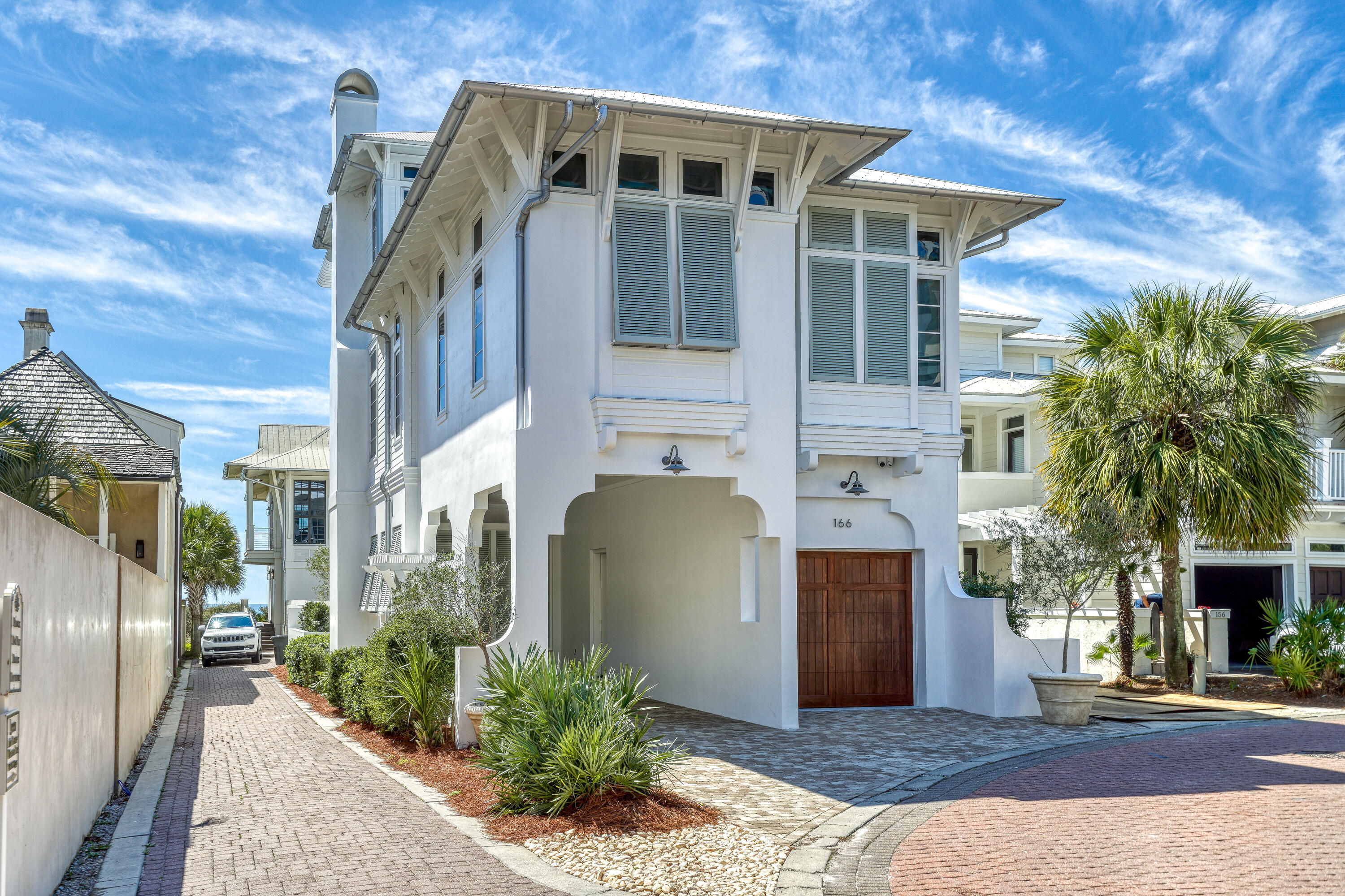 One back from the Gulf in the exclusive, gated community of Water's Edge, this stunning three-story coastal retreat offers the rare combination of luxury, privacy and direct access to the best of 30A. Perfectly positioned between the iconic communities of Rosemary Beach and Alys Beach, the home captures expansive Gulf views from multiple levels and sits just steps from the private beach access. With only a two-story home in front, this three-story luxury residence enjoys expansive Gulf views from all over — a true rarity on the second row. Designed by architect Tyler Doin and built by Suntec, the home features 5 bedrooms (4 king suites + 1 bunk room) and 5.5 bathrooms, and comfortably sleeps 12. Highlights include a chef's kitchen with pecky cypress accents, smart home technology and a wall of folding glass doors opening to a Gulf-facing porch. The third-floor primary suite is a private sanctuary with a sundeck, sleeping porch, wet bar and soaking tub. Outdoor living is equally refined, with a heated pool and spa, summer kitchen, fireplace, and teak lounge areas. Additional features include impact-rated windows and doors, 10'-13' ceilings, a dumbwaiter, laundry chute, and full designer furnishings by Heather Lollie. Consistently ranked among the top luxury homes in the Rosemary Beach rental program, this property offers proven income and an exceptional coastal lifestyle in one of 30A's most desirable communities.