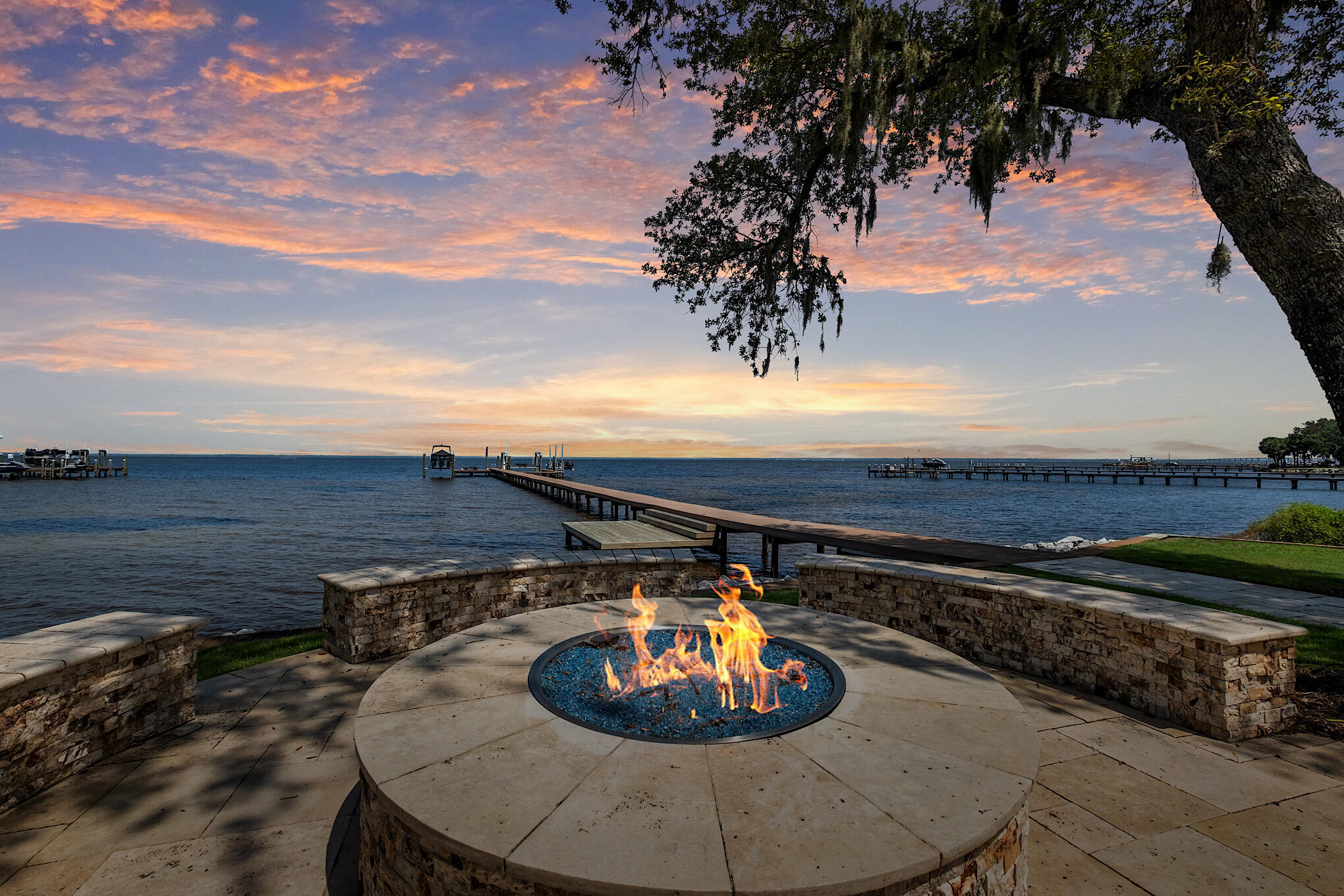 Masterfully built and primely positioned, this deep water estate located within the prestigious gated community of Kelly Plantation offers over 220' of premier frontage on the Choctawhatchee Bay situated on an acre of land yielding exemplary privacy while being in excellent boating and driving proximity to all of the world class amenities, restaurants, shopping and dining in Destin, Florida. The deepwater private dock (where a 75' yacht was previously moored) consists of low maintenance trex decking, three jet ski lifts, a paddleboard launch and two impressive deep water boat slips. Exceptional architectural facades blended with mature tropical landscaping yield a dramatic entrance from the front elevation of this regal compound home. The main house is comprised of mostly single level living with an expansive open floorplan that takes full advantage of the extraordinary "big sky" bay views and northwest orientation. Notable features include a beautiful first level primary suite with oversized an living area and direct connection to the rear screened lanai overlooking the water as well as an outstanding spa-like ensuite bathroom complete with dual vanities, spacious soaking tub, walk-in shower with suspended glass and massive closet space. This home is outfitted with smart technology including home automation throughout as well as meticulous maintenance by the current and previous owner. The chef's kitchen is adjacent to the private screened lanai and formal living room complete with custom cabinetry, Wolf gas range as well as Sub zero refrigeration and solid stone countertops. The outdoor living area is not only a paradise but an incredibly private oasis flanked by natural vegetation and maturely landscaped foliage complete with a screened sun deck, pool & spa as well as an outdoor grilling area, covered patio with gas fireplace, powder bathroom and full guest ensuite with a accessibility from the private parking court. Other notable features include an expansive garage with an adjoining carriage house complete with it's own kitchen, living room and guest suite. Other notable features include four additional guest suites on the second level of the main house, private office space, in-home movie theatre, formal dining and ample room for entertaining.

This rare opportunity to secure a deep water property with open bay views is also highlighted by its location within Kelly Plantation. Living in Kelly Plantation, you're in excellent proximity to Whole Foods, great schools, the Destin Executive Airport and the Destin-Fort Walton Beach Airport (VPS) and easy access to and from the Mid-Bay Bridge. In addition, the Destin Harbor are and the beautiful white sand beaches of the Emerald Coast are just a short drive away as well; truly a boater enthusiasts dream spot.