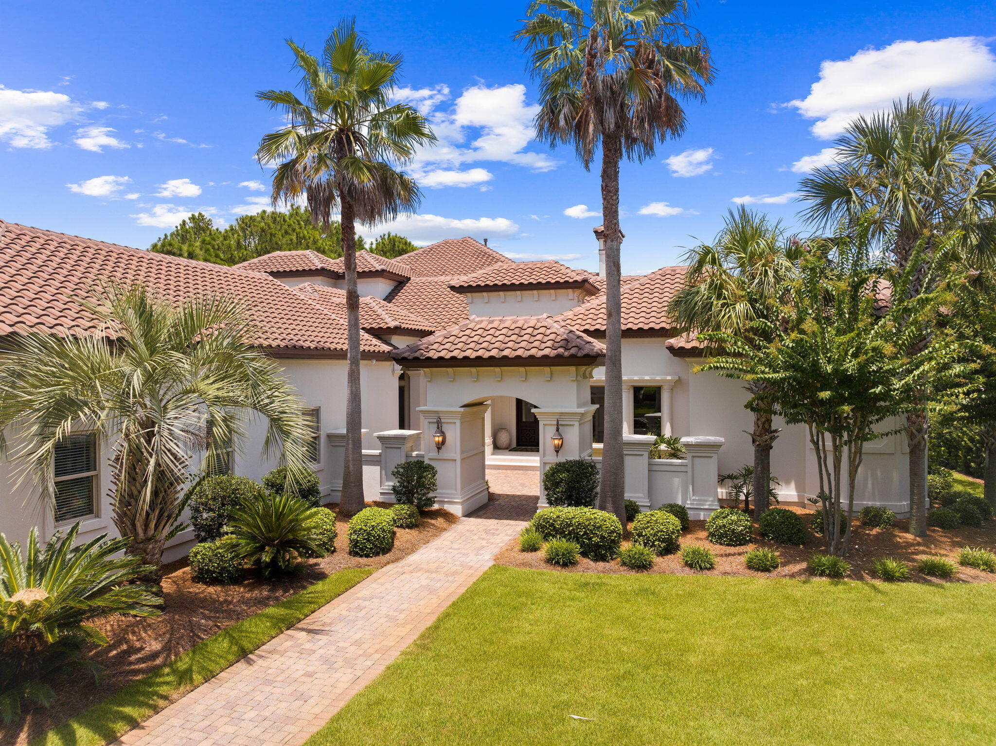 Experience unparalleled luxury and grandeur in this stunning lakefront home, nestled within the exclusive gated community of Burnt Pine at Sandestin Golf and Beach Resort. Fully remodeled and meticulously designed with high-end finishes, this exceptional estate offers a lifestyle of elegance, comfort, and sophistication. This magnificent Coastal Mediterranean-inspired villa, with its stucco exterior and red tile roof, rich stone interiors, textured woods, and exquisite wall coverings, provides an unparalleled lifestyle of luxury and privacy in one of the most prestigious locations.
As you step inside, you'll be immediately struck by the breathtaking views of the newly refinished pool and outdoor oasis through the expansive picture window, framed perfectly by the serene golf course lake and #10 green of the Burnt Pine Golf Club beyond.
The living areas on the main floor are perfect for both family life and entertaining guests. A grand foyer sets the tone for the elegance found throughout. The gourmet kitchen, adorned with marble countertops, Thermador appliances, and custom cabinetry, is a chef's dream. Adjacent to the kitchen, the formal dining room has been tastefully updated with refined finishes, creating an ideal setting for elegant dinners and celebrations. The living area, spacious and inviting, features a gas fireplace and built-in shelving, providing a warm and sophisticated ambiance perfect for both relaxed family moments and stylish entertainment.
The temperature-controlled wine cellar is a connoisseur's dream, while the seamless flow between indoor and outdoor spaces ensures that you can enjoy the best of Florida resort-style living. Step outside to discover an entertainer's paradise, complete with a summer kitchen, stone fireplace, temperature-controlled pool, spa, and an outdoor living area equipped with a gas fireplace, gas grill, refrigerator, wine cooler, outdoor air conditioners, and multiple outdoor TVs. A retractable sliding glass door connects the outdoor amenities to the indoor living spaces, creating an incredible space for entertaining.
The primary wing of this estate is a sanctuary of luxury and comfort, thoughtfully designed to cater to your every need. It features a sprawling primary bedroom that exudes tranquility and elegance, with ample space for relaxation. A dedicated office space ensures a quiet, productive environment for work or study. The spa-like primary bath is a haven of indulgence, complete with high-end finishes and fixtures, providing a serene retreat for unwinding after a long day.
Rounding out the first floor, you'll find a conveniently located half bath for guests, a secondary entrance for added convenience, and a spacious three-car garage to accommodate multiple vehicles. The expansive laundry and mud room is designed for functionality and style, featuring ample storage space and a practical dog bath station to keep your furry friends clean and happy. Every detail of this first floor has been carefully considered to provide convenience, luxury, and ease of living.
The upstairs of this magnificent home offers two beautifully appointed bedrooms, each featuring its own en suite bathroom, providing comfort and privacy for family and guests. The expansive secondary living area is perfect for relaxation and entertainment, boasting new plush carpets that add warmth and elegance to the space. This additional living area also includes a wet bar, making it an ideal spot for casual gatherings. The extensive deck off this area offers breathtaking views of the lake and golf course, enhancing the upstairs' appeal as a versatile and luxurious retreat.
Additionally, above the mudroom, you'll find a secluded bedroom that serves as the pinnacle of privacy while remaining seamlessly connected to the main home. This tranquil retreat features its own en suite bathroom, making it an ideal space for guests or family members seeking a quiet, private haven. The thoughtful design ensures that this bedroom offers a peaceful escape without sacrificing the convenience and luxury of the main living areas.
This home has seen numerous significant improvements to enhance its luxury and functionality. A whole-home generator ensures uninterrupted power supply, while the kitchen cabinets have been freshly repainted to complement the high-end finishes. LED lighting has been installed throughout the house for energy efficiency and modern appeal. The smart home system, featuring Control 4 and Lutron lights, offers advanced home automation. The pool deck has been resurfaced and now features new lighting and luminaires, creating a perfect outdoor retreat. The entryway and lanai have new tile installations, adding a touch of elegance. The master bedroom benefits from a new HVAC system for optimal comfort, and a new vent-a-hood has been installed over the outdoor BBQ for superior ventilation. Additionally, new carpet in the upstairs area ensures a cozy and welcoming space for years to come.
Living in this exclusive community means you'll have access to Sandestin Golf and Beach Resort's abundant amenities, including 5-Star golf courses, tennis and pickleball courts, biking and hiking trails, a 210-slip full-service marina, and the vibrant Baytowne Wharf for dining, activities, and shopping. The Grand Boulevard Town Center, featuring premier restaurants, retail shopping, a movie theater, and Publix Grocery, is just a short golf-cart ride away.