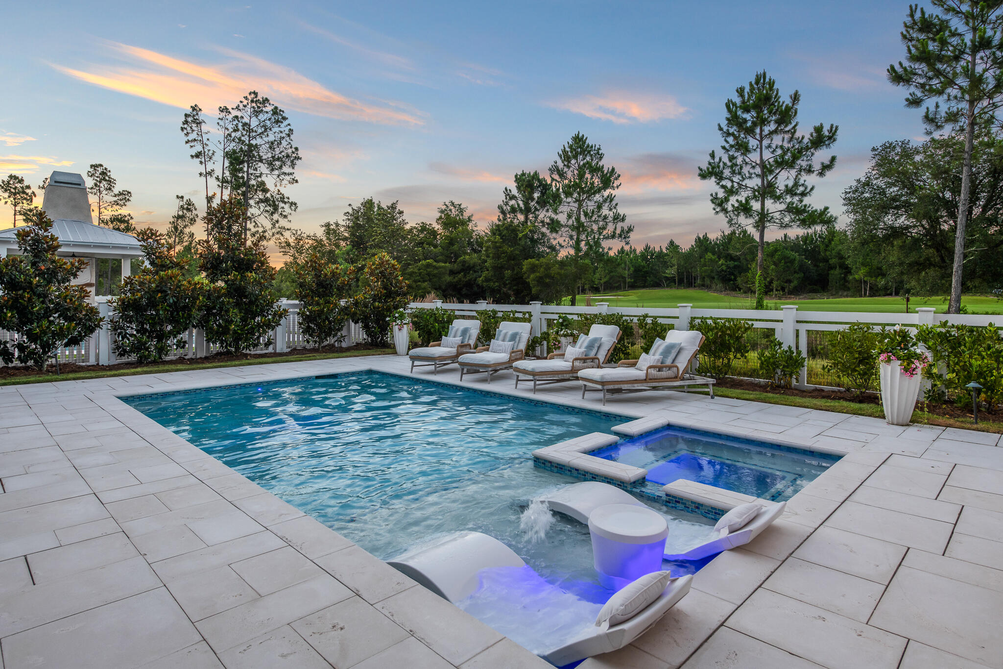 From the moment you arrive at this exceptional Romair-built Darien plan, you're greeted by timeless architecture and a rare, unobstructed view of the Origins Golf Course—one of only a handful of homes in Watersound Origins to enjoy this privilege. Nestled on a prime lot, this luxury estate offers more than 4,600 square feet of thoughtfully designed living space, including a private carriage house, expansive outdoor entertaining areas, and serene surroundings that elevate the everyday. Step inside to soaring 12-ft. ceilings and walls of transom windows that fill the home with natural light. The heart of the home is an entertainer's dreaman open-concept great room with wide-plank engineered hardwood floors, a cozy fireplace, and seamless flow to the outdoors. The chef's kitchen is anchored by a striking 12-ft. island and appointed with Wolf and Sub-Zero appliances, a 48-in. gas range, Scottsman ice maker, custom cabinetry, and generous hidden storage throughout. Tucked away on the main level is the primary suite, a tranquil retreat complete with a spa-inspired bathroom and an expansive walk-in closet. Upstairs, a second living area offers versatility for media, lounge, or game space and is paired with a powder room and a second master suite, ideal for hosting family or guests. 

Each of the home's bedrooms includes a walk-in closet, ensuring comfort and function in every corner. Unique to this floor plan is the interior access to the spacious carriage house, a feature exclusive to this model in Origins. Perfectly suited for guests, extended family, the carriage house features a private bedroom, full bathroom, kitchenette, walk-in closet, and even its own washer and dryer. But it's the outdoor living that truly sets this home apart. Oversized sliding doors lead to a spectacular 12-foot-deep, covered porch with Cumaru hardwood decking, extending your living space into the outdoors. Overlooking the golf course and surrounded by native landscape, this private oasis includes a heated pool and spa, a cabana with an Isokern fireplace, a summer kitchen, and multiple areas for lounging, dining, and entertainingincluding a table that seats 10 or more. 

Whether it's a quiet evening under the stars or a vibrant gathering of friends, this setting delivers effortless ambiance. Additional touches include a beautifully designed laundry room, custom garage slat-wall storage, and a lighting package allowance to personalize the space further. With no homes behind you and only green space and golf course views beyond, the setting is incredibly peaceful, especially in the evenings. Located in the highly sought-after Watersound Origins community, this home offers access to unmatched amenities, including a resort-style pool, fitness center, sports courts, nature trails, Lake Powell dock access, and the brand-new Watersound Town Center, featuring Publix, restaurants, healthcare, and a weekly farmers' market.