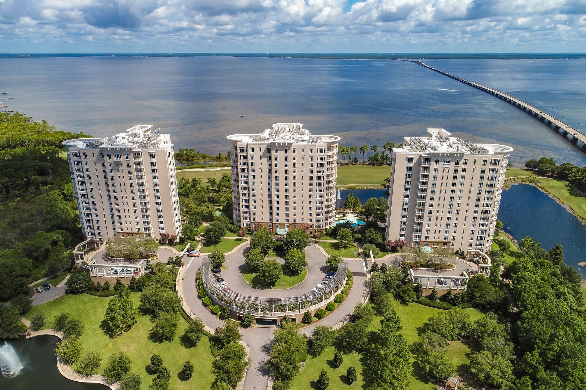 Be prepared to be WOWED! The very definition of modern luxury at One Water Place in desirable, gated Kelly Plantation and quite possibly the most exquisite penthouse on the Gulf Coast, carefully designed and finely appointed, with absolutely no detail overlooked. Modern yet warm elegance, with clean lines and architectural features and a spacious, open floor plan is perfect for family and entertaining with a large great room, see through fireplace and adjoining open piano stage. The open concept living area features the popular Castleton floor plan oval living room with the signature wrap around balcony and summer kitchen, a gourmet kitchen that any chef would envy with quartz counters, large center island, abundant quiet close custom cabinetry, large walk-in pantry, professional grade stainless appliances including 45'' Wolf range with grill and griddle, trapeze Zephyr hood, 30'' single wall Wolf oven, steam oven, warming drawer, Sub Zero 48" side by side refrigerator/freezer, wine fridge, Bosch dishwasher, large center island.   Roomy dining area with glassed wine storage. The study has a wall of windows offering direct views to the Gulf and access to the balcony. There's only one hallway in the entire residence and it leads to the impressive and luxurious master suite.....double doors open into the suite and the closet of your dreams, a spacious bedroom with bay views and a balcony and a sumptuous spa inspired bath that you'll never want to leave,  with large walk-in shower, soaking tub, private water closet, extra long double vanity and additional makeup vanity.  The east side of the residence offers two guest bedrooms, two baths, an additional laundry center and spaces that are currently used as storage, an art studio with a fireplace and a very large room used as a sewing/craft room.  These areas could easily be transformed into an in-law suite, additional guest rooms, game room....the possibilities are endless.  The finishes are every bit as luxurious as the rest of the penthouse.  Additional features include four balconies totaling approximately 2,000 square feet and offering forever views, rectified full-bodied porcelain tile floors, gorgeous light fixtures, chandeliers and pendant lighting throughout, 8 foot solid wood doors, reverse trayed ceilings,  three fireplaces (two direct vent in living room and art studio and family room fireplace features Swarovski crystals), 8-zoned HVAC, each unit has a dehumidifier and is filtered on the supply and return using electrostatic and UV light and each zone can be controlled from smart phone/tablet. home automation system adjusted manually or by any smart phone or tablet, LED lightings, audio system, two separate home theater setups (living and family rooms) with in-wall subwoofers, 2 1/2 car private garage in parking garage.  One Water Place residents enjoy the very finest of amenities including two large owner guest suites for overflow guest, a state of the art health club and fitness center, spa treatment rooms, resort bi-level pool with water feature fountain, heated lap pool and spa, wine room, catering kitchen, sports lounge and billiard room, card room, pet park, workshop/hobby room, potting room, screened outdoor patio with fireplace, herb/flower gardening area, bocce ball court, tennis, owner's club, Kelly Plantation Golf Club with restaurant, member's lounge, miles of walking paths, activities director, special events and more!  This is a must see for the discriminating buyer! As always, all dimensions important to the buyer should be verified.
