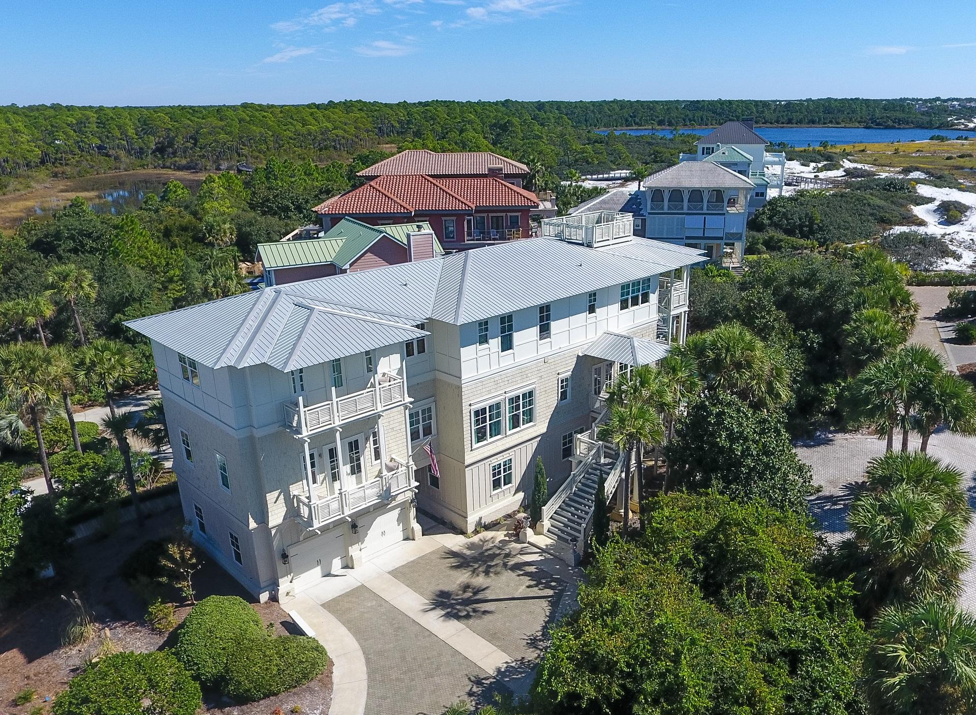 An established, strong cash-flow vacation rental, specifically designed for large groups, this vibrant beach house boasts a special, south of 30A location, just one tier from the Gulf , within the gated community of Seclusion Dunes. Conveying exceptional unobstructed and forever protected Gulf views over preserve lands, this 9 bedroom, 8.5 baths coastal beach house was completed in 2012, boasting an attractive design plan of 6,275 square feet of conditioned space & 2,213 square feet of additional covered space, focusing on impressive exterior spaces that marry outdoors with indoors. With attention to detail in designing the ultimate beach house, this rental machine will exceed $240,000 in rental income. The lower level great room to opens to the pool deck, an impressive outdoor living area featuring a heated pool, with a private gate directly accessing the beach boardwalk. Upon entering the home, the lower level houses a great room, used as a media/game room, with morning kitchen. A bunkroom, guest suite, additional half bath, and a large laundry and utility room are all also on the lower level. Mounting to the second level, the main living area features a large open plan with kitchen, dining, breakfast seating, and living all open, ample windows inviting bright light and expansive Gulf views. The second level houses the master suite and the adjoining guest quarters with private entrance through the garage. The third level presents additional guest quarters with 5 king beds and an additional bunkroom and Gulf views from the den, while the fourth floor lookout has unobstructed Gulf views across Deer Lake State Park and the Gulf of Mexico. Come discover the serenity of Seclusion Dunes!