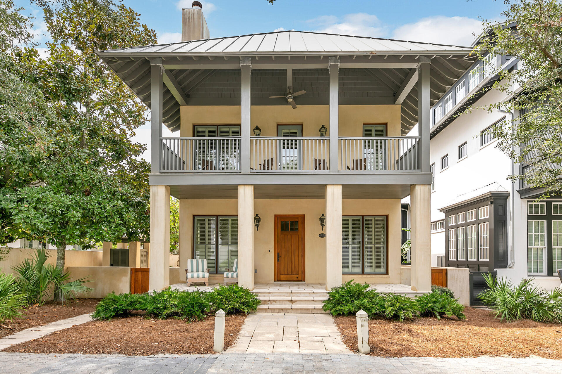 This stunning West Indies inspired home in Rosemary Beach has been completely transformed from its original roots.  A carriage house was added in 2012, along with a stunning courtyard with wood burning fireplace.  Light and bright, the first floor living space of the main home retained the original shiplap walls but added a beautiful coquina inspired fireplace surround.  A gorgeous kitchen opens to the living and dining area with cabinets to the ceiling and white quartz counters.  The jewel of the first floor is the large, glassed in sunroom with views of the courtyard fireplace.  Upstairs you will find an oversized primary bedroom with an updated bath, containing both a freestanding tub and a shower.  Two other guest rooms round out the second floor.  Possible room for expansion exists in the 24 x 12 foot attic space that is framed out and ready to be converted to living space.  Just outside the back door and up a wide staircase, you will find the carriage house.  Your guests may never leave this charming space!  The main level contains the living area, full bath and a small kitchenette with refrigerator drawers.  A full size staircase leads to the sleeping loft.  Just steps away from the Sky Pool, with the retractable roof for year round swimming and also from the tennis courts.  The square footage includes the heated and cooled space that is accessed from the outside and is currently used as storage.  All information in the listing is deemed to be correct, please verify any information that is important to you.