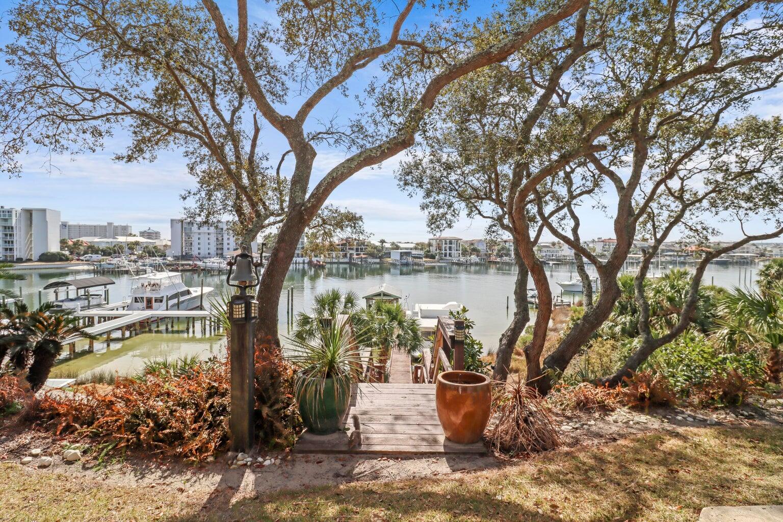 Experience true waterfront living with this exceptional harbor-front home in the heart of Destin. Boasting 85 feet of prime harbor frontage, this 4-bedroom, 3-bathroom single-family residence offers panoramic views of the Destin Harbor and an unbeatable boating lifestyle.
The property features a deep-water dock accommodating one large vessel, plus storage space for two additional boats, making it ideal for avid boaters and water enthusiasts. From sunrise to sunset, enjoy stunning harbor views, watching boats cruise by and fireworks light up the evening sky.
Inside, the home offers a spacious and functional layout designed for both everyday living and entertaining. Large windows frame the water views, filling the home with natural light and coastal charm.