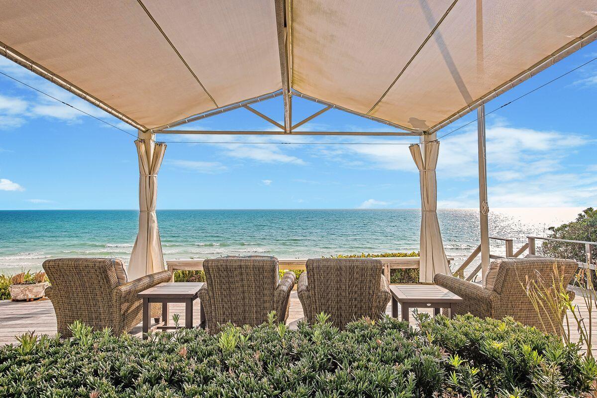 This Seagrove gulf front home, crafted by Thurber Architects, exudes coastal sophistication and elegant charm. Upon entry, the sweeping gulf views from the beach-facing living area, with its floor-to-ceiling windows, will take your breath away. Every detail in this 4,276 square foot home has been thoughtfully considered, from the floating European white oak staircase to the soothing color palette and exquisite finishes. Set atop a high beach dune, this one-of-a-kind residence features 60 feet of private direct beach access and generous gulf-frontage. Spend evenings by the fireplace in the living room or entertain guests in the dining room or under the Sunbrella Arbor on the gulf front pavilion. The first-floor living area includes a private loggia with a heated spa pool and a Nano glass door system that folds away to showcase the gulf front garden with landscape lighting and tropical views.  The gourmet kitchen is a masterpiece of form and function, with double Bosch dishwashers, double ovens, a Wolf warming drawer, Subzero refrigerator, full-size wine cooler, 36" Wolf cooktop, induction cooktop, and icemaker.

The floor plan includes a main floor master bedroom with gulf views, his and her closets and an en suite bath with split vanities. The second floor primary  master suite showcases panoramic gulf front views from every window.. This luxurious oasis is accentuated with a morning bar and a private gulf front veranda to enjoy your morning coffee or relax with a good book.  Complimenting this master suite is a california closet and private laundry and wet bar area. Both master suites are complete with radiant heated Marble floors, toe heaters, a walk-in shower with glass tiles and custom cabinetry.  Two additional guest bedrooms with en suite baths complete the second floor living space.

The state-of-the-art home technology system allows for complete control of lighting, sound, and security with the Lutron and Control 4 systems. Other features include an elevator, two laundry areas,a double car garage, Dornbracht plumbing fixtures and custom drapes with blackout lining along with electronic shades. 

Constructed with fortified ICF construction and sea wall, this Old Seagrove Beach property offers peace of mind and protection from the elements. A full list of amenities and features is available upon request.