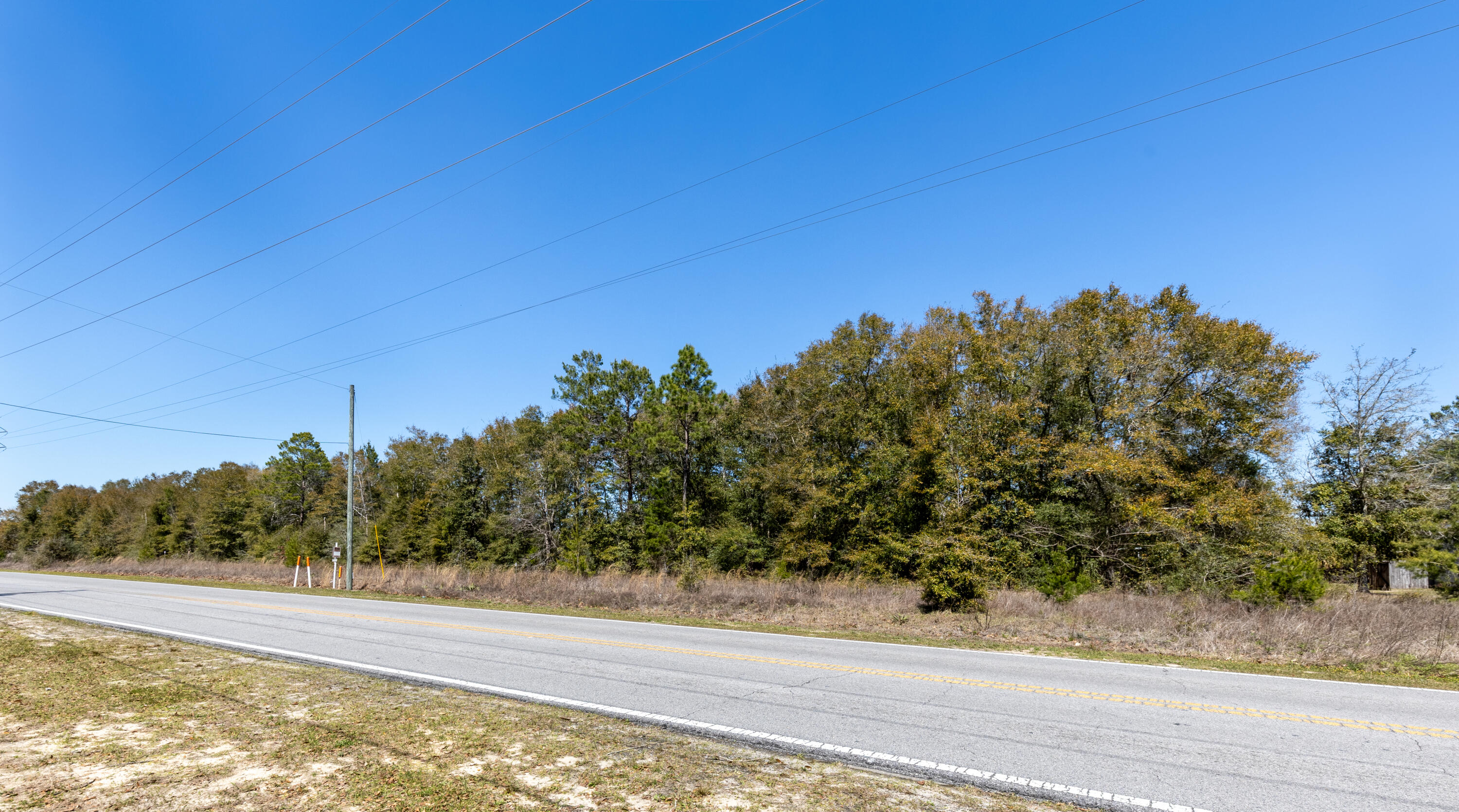 Two Prime Parcels B & C (Potential for 4 Home sites total) -  Zoned R-1 Single-Family Residential - 
Parcel B (.67 acres) Parcel C (.63 acres).

Seize this exceptional opportunity to own is 1.385 total acres of prime land on Walton Road, conveniently located less than a mile from Walton High School in the charming town of DeFuniak Springs, FL. This residential zoned (R-1) parcels have public water and sewer available at road (tap fee due), making it a ready-to-build site for your dream home.

Located in Flood Zone X with no wetlands, as per Walton County GIS maps, this property offers peace of mind and ease of development in a serene yet highly accessible location--just minutes from shopping, dining, medical facilities, and schools, and less than Less than 50 minutes to the beaches of 30A. Why You'll Love This Location:
DeFuniak Springs Highlights:

    Lake DeFuniak - One of only two nearly perfect circular spring-fed lakes in the world (40 acres), with a scenic walking trail, dock, and seasonal public swimming and fishing.
    Historic Downtown District - Less than one mile away, featuring the famous Chautauqua Building, charming shops, and community events.
    Annual Christmas Lights Festival - Showcasing over 10 million lights around the Lake Yard, attracting visitors from across the region.

Outdoor & Recreation:

    King's Lake - A well-stocked 580-acre reservoir just 6.3 miles north, perfect for fishing enthusiasts (record bass catch: 17.25 lbs!).
    Gulf of Mexico's White Sand Beaches - Access pristine beaches within 35 minutes to an hour, including Henderson Beach, Miramar Beach, Santa Rosa Beach, and more.
    Crab Island in Destin - A world-famous boating destination on the Emerald Coast.
    Emerald Coast Zoo & Chautauqua Winery - Local attractions perfect for family outings.

Endless Outdoor Adventures:

    Multiple hiking trails including Florida Trail (Eglin & Nokuse), Lakewood Park, and Lafayette Creek.
    Natural Springs & Parks - Explore Vortex Springs, Ponce De Leon Springs, Morrison Springs, and Florida Caverns in Marianna.

Key Features:

*1.385 acres - Zoned R-1 for single-family residential
* Water & sewer installed (tap fee due)
*Flood Zone X - No wetlands (per Walton County GIS maps)
* Minutes to downtown DeFuniak Springs & shopping
*Less than 50 minutes to the beaches of 30A
*Close to fishing, boating, hiking, and natural springs

This rare homesite blends convenience, nature, and lifestyle in one of Florida's most charming communities. Don't miss your chance to own a piece of DeFuniak Springs - schedule a visit today!

Buyers are responsible for verifying all property details and dimensions. Information is believed to be accurate but is not guaranteed.