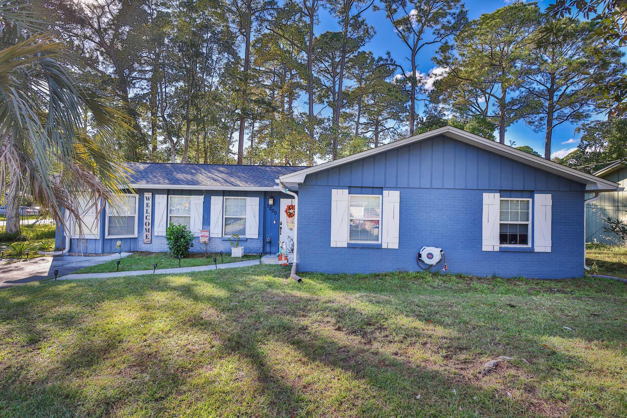 Welcome home to this 5 bed/ 2 bath gem nestled in quiet Greenacres, central to both AFB/s, shopping, restaurants, schools, & so much more. Set on a lg corner lot this home is the perfect blend of modern updated comfort, flexibility in many spaces, & spacious outdoor entertaining/living. Inside you'll immediately notice beautiful updates, open living, dining, & kitchen floor plan great for entertaining. The kitchen offers plenty of cabinets, granite counters, & a breakfast bar. Each bedrm is nicely sized, & 1 currently serves as a wonderful flex space, ideal for a home office, nursery, hobby room, or a dream walk-in closet or convert back to a private 5th bedrm. The options are endless, giving you the flexibility to make it fit your lifestyle. Outside, enjoy your private backyard, perfect for weekend barbecues, playtime w/the kids or pets, or simply relaxing under the Florida sun & shade of the pine trees. You'll love the peaceful setting a lg corner lot offers while still being close to it all.  Whether you're a first-time buyer, growing family, or someone looking to simplify & settle into a great move-in-ready home. Roof, indoor AC unit, & water heater '20, outdoor unit 2012. It's turn-key and ready to be yours!