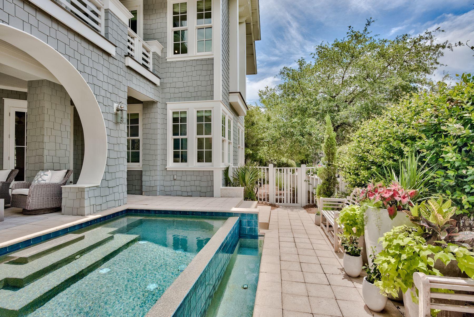 Professionally decorated and fully furnished by Beau Interiors, this stunning home is situated on a large corner lot and boasts 4,800 square feet of living with six bedrooms, six and a half bathrooms, multiple living spaces, an elevator, private infinity edge pool, carriage house and two car garage. Additional notable features include gorgeous hardwood floors, custom marble and tile work in the kitchen and bathrooms, Pecky Cypress beamed ceilings with additional accents throughout, a gourmet kitchen with stainless steel commercial grade Thermador appliances, a gas fireplace perfect for keeping cozy on chilly evenings and a fourth floor tower with gulf views. This floor plan offers an impressive, open living space on the first floor flowing to outdoor living areas surrounding the pool, with additional indoor and outdoor living and outdoor living spaces on the second and third floors. The boardwalk adjacent to the home leads to the expansive mile-long private beach of WaterSound. Enjoy additional amenities such as the beach club, fitness center, tennis courts, walking trails and onsite dining in addition to the nearby renowned shops and restaurants of Scenic Highway 30A.