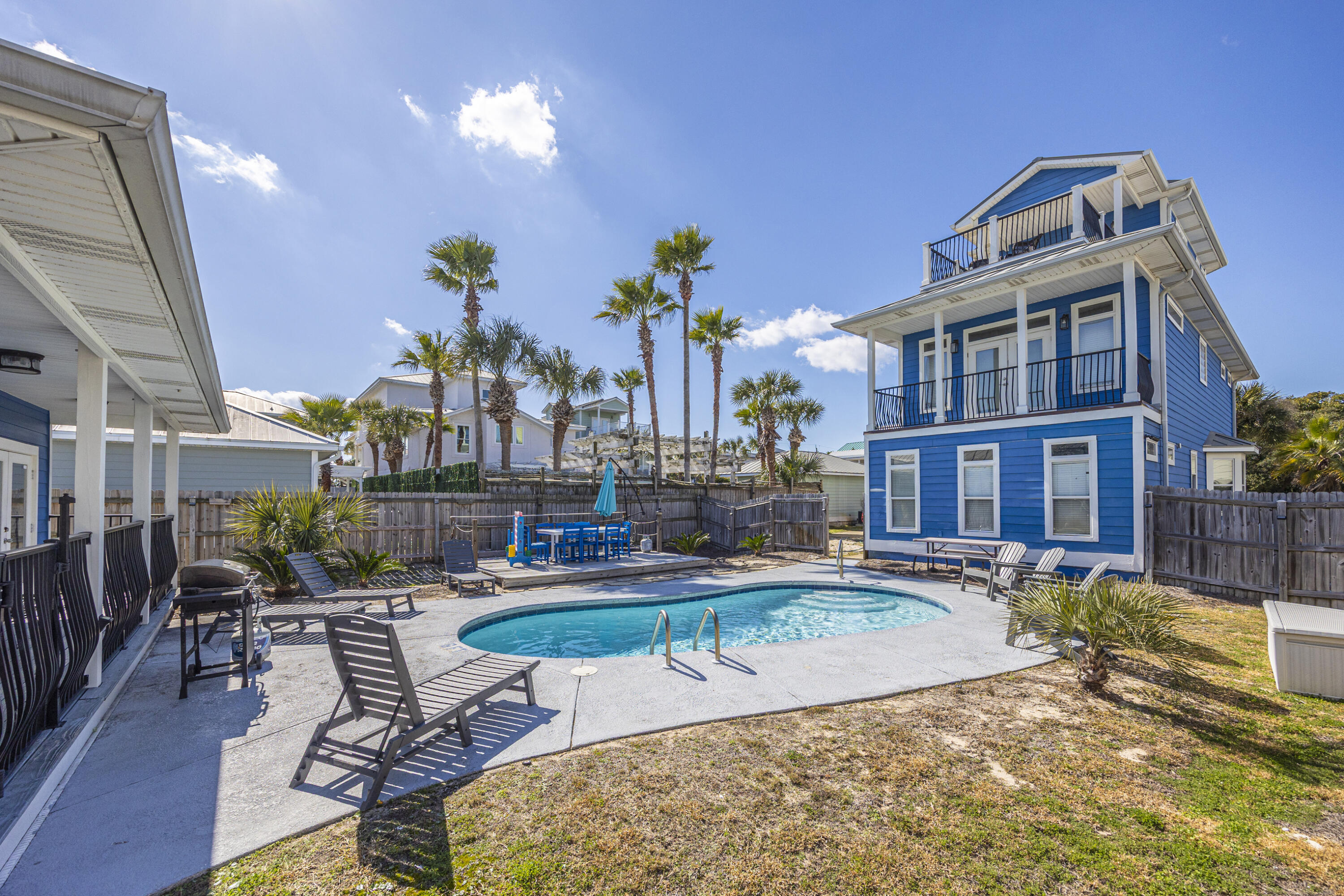 YEAR TO DATE BOOKINGS AS OF August 31, 2026 $199,579.48. PRICED BELOW APPRAISAL
Located in the highly desirable Crystal Beach community, this exceptional three-story coastal retreat offers a rare ''two homes in one'' configuration just under one block from Destin's renowned white-sand beaches. The property includes a golf cart, making beach access and cruising the neighborhood effortless and convenient. 
The main residence features 4 bedrooms, while a separate 2-bedroom carriage house provides additional privacy and  flexibility, perfect for multi generation living, hosting guests, or maximizing rental income. Together the property comfortably accommodates up to 18 guests,  making it perfectly suited for both personal enjoyment and strong short-term rental performance. Designed for coastal living & entertaining, the home offers multiple outdoor spaces including four private balconies, peek-a-boo Gulf views from the third level, and a fully fenced backyard with a heated pool & expansive deck. The thoughtfully designed interior spans three levels and features multiple en-suite bedrooms, a third-floor loft with kitchenette, and open-concept living, dining, and kitchen areas ideal for gathering.

The carriage house includes two bedrooms, a full bathroom, walk-in closet, and kitchenette ,providing a private retreat for extended stays or guest accommodations. Additional highlights include ample parking and generous storage throughout. 

From an investment standpoint, the property has demonstrated strong rental performance, generating $163K in rental income in 2025, with $109K already booked for 2026 to date. Centrally located near Destin's premier dining, shopping, and entertainment, this home delivers an exceptional blend of coastal lifestyle, prime location and proven income potential in one of the area's most sought-after beach neighborhoods.