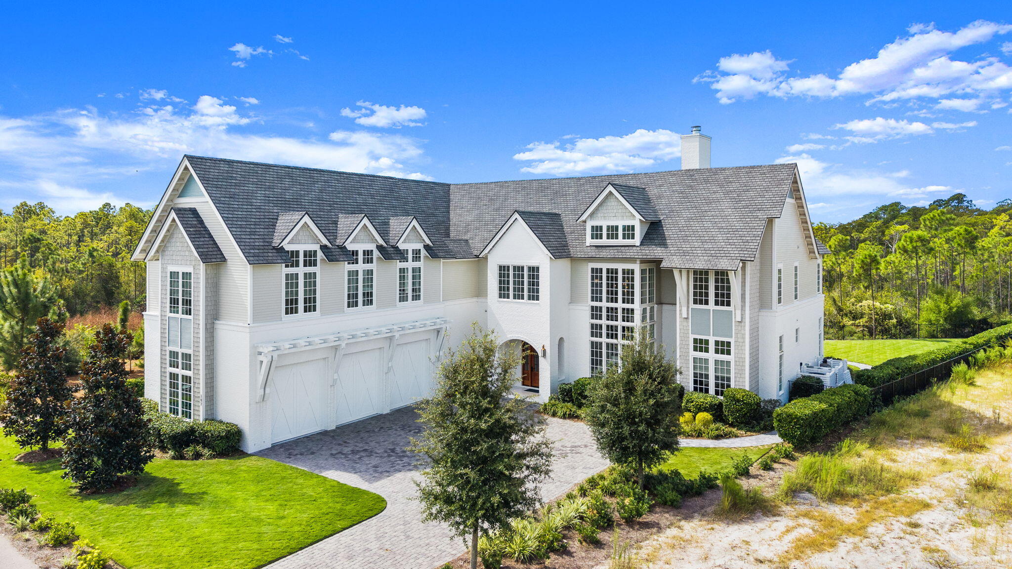 Move-In Ready Luxury Estate in WaterSound Camp Creek | Furnished Opportunity | Premium Private Lot-Experience the best of private club coastal living in this exceptional 2023 custom estate in WaterSound Camp Creek, ideally positioned just inside the gated entrance on a rare premium homesite backing to protected Camp Creek Golf Course green space. With expansive natural views and a spacious fenced yard rarely found in the community, this home offers both privacy and immediate lifestyle access. Offered partially furnished with accepted offer, this residence provides the opportunity to skip the 18-24 month build timeline and begin enjoying the WaterSound lifestyle immediately. Located within walking distance to the Gulf and the renowned Camp Creek Golf Course.  Club membership included! Watersound Club includes access to championship golf, private beach club, tennis, wellness facilities, dining, and luxury resort amenities. 107 Golfridge was Designed by Stackable | Mracek Design Group, the home features six private ensuite bedrooms, including two main-level king suites, along with two additional half baths and a dedicated pool house bath. The dramatic two-story great room showcases exposed beams, custom iron lighting, and a striking painted brick fireplace with reclaimed barn-wood floating mantle. Oak plank flooring runs throughout both levels, creating timeless coastal elegance. The chef's kitchen is equipped with a premium Wolf and Sub-Zero appliance package, ice maker, wine chiller, marble countertops, and custom soft-close cabinetry with brushed gold and solid brass hardware. A unique bourbon and wine tasting room offers the perfect setting for entertaining or a private creative retreat.
A set of hurricane-rated solid maple French doors opens to a massive screened summer room finished in tumbled limestone and marble, seamlessly connecting indoor and outdoor living spaces.
The outdoor environment is designed for entertaining and relaxation, featuring: Resort-style saltwater pool-Limestone pool deck-Fully equipped outdoor grill station and granite bar-Elegant pool house with fireplace, half bath, and storage.  Surrounded by natural preserve and golf course green space, the property enjoys 360-degree protected views and exceptional privacy. Extensive landscaping, architectural lighting, and a private iron fence create a true resort-style backyard. Upstairs, four additional ensuite bedrooms include two private guest suites, while a spacious media and recreation suite with attached bedroom and bath provides an ideal layout for multi-generational living or extended guests.
Additional highlights include: Dual laundry rooms (main level and upstairs)-Extensive storage throughout-Side-entry 3+ car garage.  Professionally designed landscaping and illumination package
This extraordinary estate offers a rare opportunity to own a move-in ready luxury home within one of the most exclusive golf and beach club communities along 30A.  Buyer or buyer's agent to verify all advertised home, community, club, and financial details.
