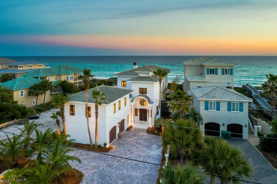 Experience luxurious gulf front living on 30A. Stunning architecture and spacious design characterize this private beachside retreat. Towering over the Gulf of Mexico, the emerald water views from every room are breath taking. This estate features a lavish large gulf side pool, private beach walk-over and a well-equipped summer kitchen to create the ultimate outdoor living space. This 5,743 square foot home offers 3 king suites, 1 queen suite, 2 bunk rooms, and 6.5 bathrooms; comfortably sleeping 24. The property boasts an enormous great room overlooking the Gulf of Mexico featuring a chef's kitchen, shuffle board table, dining for 16, wet bar, huge living area and a grand fireplace. The massive wine cellar is situated within the incredible tasting room featuring an additional wet bar equipped with all of the essentials. The large private master suite is located on the second floor and offers incredible views of the gulf from the huge bedroom, exquisite bathroom and private porch. The secluded carriage house provides a space away from the main house and contains a separate kitchen, bedroom and living space. Additional amenities include a grand foyer, built in bunks, 2 car garage, ample parking, all the necessary AV wiring, a geothermal HVAC system and a large utility room with a pair of washing machines and dryers. All furnishings with the exception of personal art convey with the property. Do not miss the opportunity to experience gulf front luxury living at its finest. Buyer to verify all dimensions.