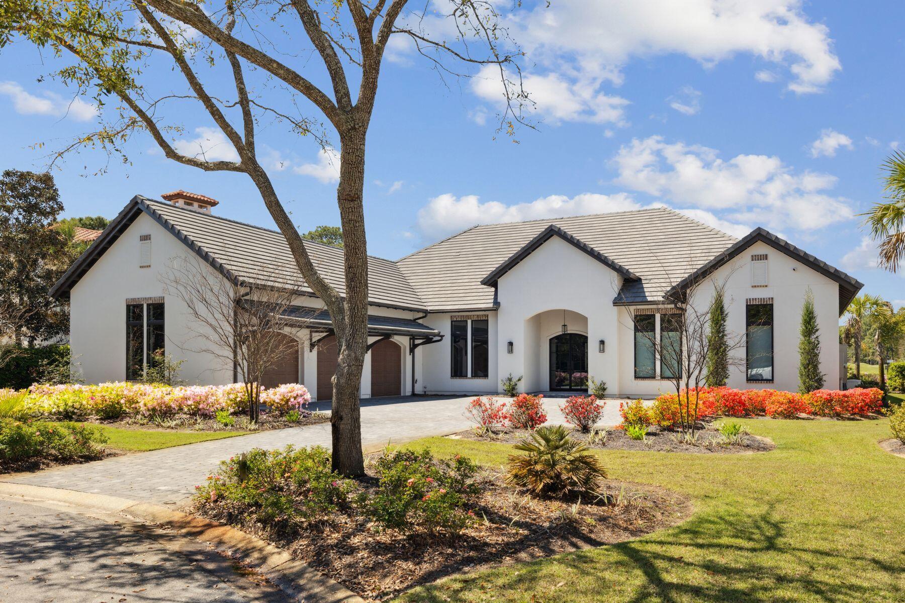Built in 2022 to exacting standards by Coastal Custom Homebuilding, this outstanding Mediterranean-style residence showcases the best of everything. Sitting on a prime, almost half-acre lot with expansive golf and lake views, this very private home has a stunning pool and spa, lofty rooms, high-end fixtures and coveted chef's kitchens both indoors and out. Laid out for living all on one level, it boasts a split floor plan with four beautiful bedrooms served by five exquisite bathrooms. A sweeping driveway heralds the approach to the home, providing ample parking and access to the insulated three-car garage with attic storage above. A covered entrance invites you inside, where the vast great room will take your breath away. Extra-tall ceilings draw the eye upwards to the deep crown molding and sparkling designer light fixtures. Beneath your feet, a runway of engineered light oak flooring carries you through the entire home. A dedicated dining area with garden views is perfect for entertaining, while a study keeps work separate from pleasure. The drama continues with dark wood beams anchoring the spacious sitting area. A realistic gas log fire provides a natural focal point. The kitchen is an epicurean masterpiece with sleek quartzite countertops and well-planned cabinetry. High transom windows deliver abundant natural light, echoed by the tall cupboards with lighted display shelves. A wishlist of high-end Monogram and U-Line appliances include a 48-inch built-in refrigerator, a smart dishwasher and a stainless microwave drawer. A huge custom hood hovers above the 48-inch six-burner professional range, where meals can be created and served on the expansive island. Perch on cushioned stools and enjoy casual dining or pre-dinner drinks at this social hub. Sliding glass doors provide a natural flow outdoors where alfresco living is at its zenith. Beneath a mansard roof, the screened pool and jetted spa offer tranquil views of the manicured rear yard, lake and fairway leading to Burnt Pine's fifth hole. In the covered porch area, a hotel-worthy outdoor kitchen is fully equipped with a refrigerator, sink, ice maker and a grill beneath a pecky cypress hood. An outdoor fireplace and a TV make this a delightful area for lounging and entertaining in all seasons. Retire to bed in the magnificent master suite. The spa-like master bathroom has elegant marble flooring, designer tile and a freestanding bathtub for leisurely soaks. There's ample space for the oversized walk-in shower and a quartzite twin vanity with a kneehole dressing table.  Beyond the doorway, the walk-in closet is fully customized with abundant shelves, drawers and hanging rails. Additional features of this exceptional residence include two tankless water heaters, audio-visual home technology and a security system. Burnt Pine at Sandestin is famous for its championship golf courses, but amenities extend to include tennis, watersports, a 223-slip marina, award-winning dining and endless shopping on Grand Boulevard and the Village of Baytowne Wharf. There's even a shuttle to carry you and your cooler effortlessly to the shores of the white sandy beach.