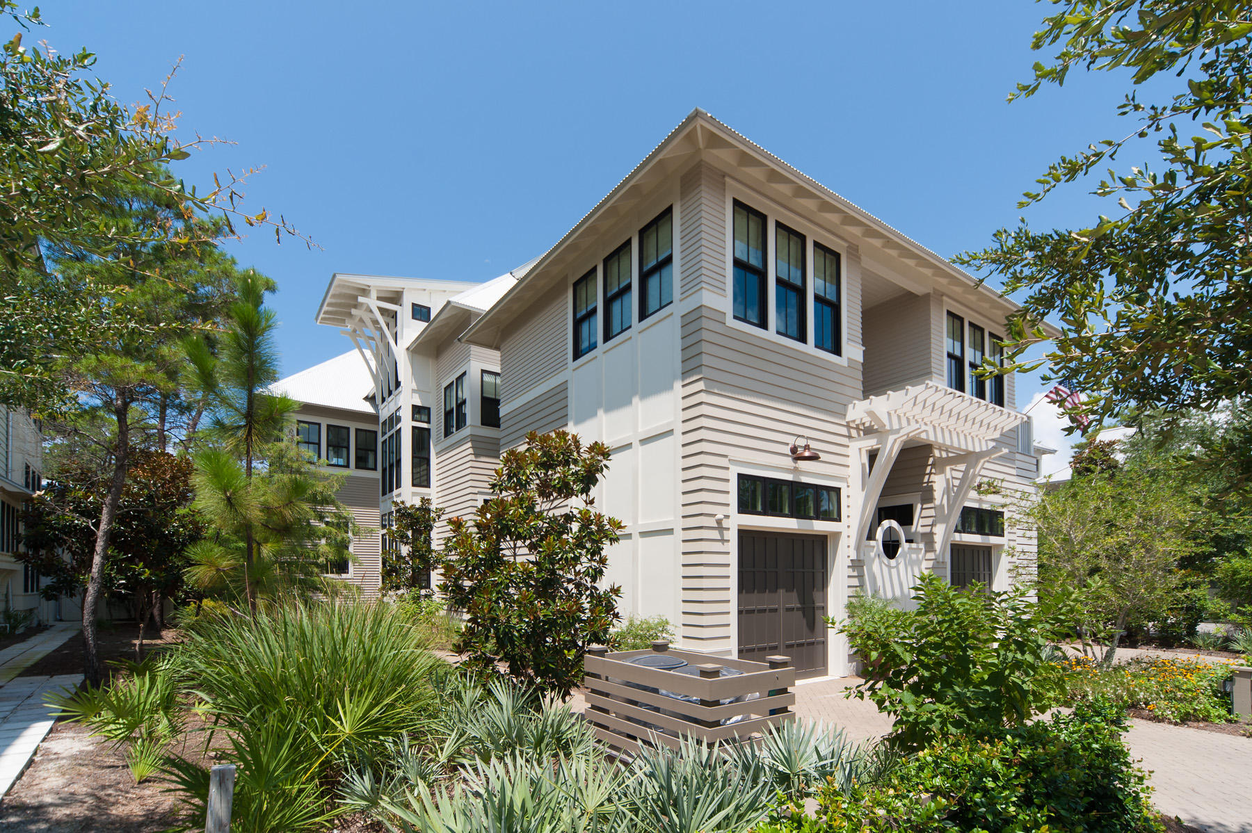 Opposite the WaterColor boat house and engaging a trail tracing the shoreline of Western Lake sits this attractively designed residence, as suited for year round living as it is the thriving vacation rental market. Open lakefront living areas invite gatherings around a stacked stone fireplace as well as an over sized kitchen island. Spend the day enjoying the outdoors from the screened back porch, and evenings in front of the gas fire pit on the adjoining deck. Conveniently on the 1st floor is one of two private, lakefront masters. Its truly spectacular spa bath features a shower for two, free-standing soaking tub, and dual vanities. Accessed by stair or elevator visiting each floor, the 2nd floor master captures lake views from its private balcony with swinging beds. Its bath with tub and separate shower sit opposite a walk-in closet, and an attached window-lined room is function flexible, serving as a comfy den, office, gym, or nursery as needed. Two additional guest bedrooms, whose private baths feature unique tile treatments, are joined by a dedicated home office with built-in desk, along with an attached guest suite with private entrance. Straddling its dedicated laundry is a living area with kitchenette, as well as a guest bedroom with private bath. A comfortable living area, wet bar, and sun deck overlooking Western Lake leave little to be desired on the 3rd floor. Every bit of space under roof is put to use, exemplified by the four sprawling storage rooms found at each corner of this floor. The foot of the pedestrian bridge, leading into Town Center and the Gulf of Mexico beyond, is just over 100 yards away. Virtually equidistant is the Sand Hill pool with whimsical frog fountains, and boat house pool nearby which paddle boards can be rented and launched into the coastal dune lake.