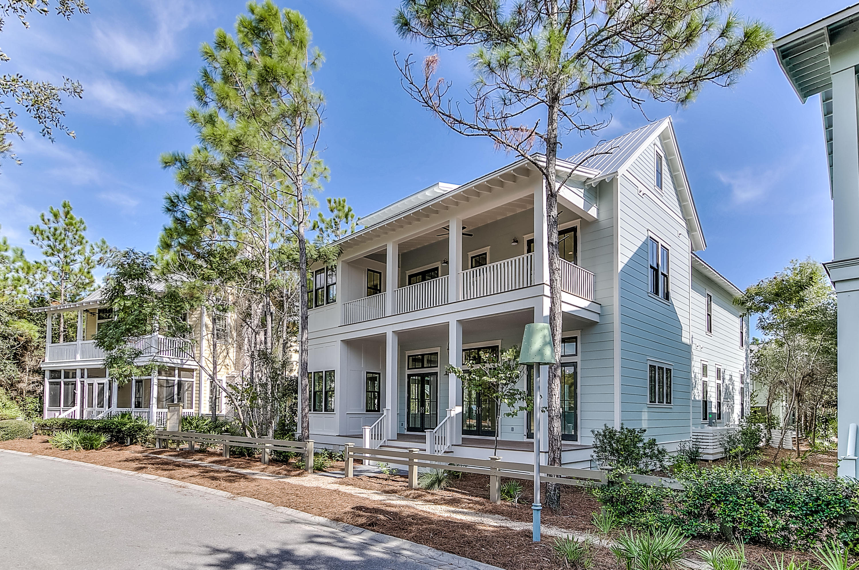 Boasting the coveted location overlooking Wood Fern Park and the new Camp WaterColor expansion (lazy river and restaurant), this new construction luxury home with 6 ensuite bedrooms, sleeps 16+, is walkthrough ready and will be completed in July - carefully planned to include every amenity desired for a perfect vacation home and a fantastic rental income producing investment. Upon entering this beautiful quality built home, your view is captivated with the grandness of the primary gathering area featuring 12' ceilings, beams, and wood walls. This 20 x 43 great room has the living and dining areas open to the enormous gourmet kitchen with farmhouse sink, Subzero, and a 48'' Wolf stove surrounded by a 12' wide island making it easy to host dinner parties with seating for 22+ . Step out through the great room rear doors to a large porch with a summer kitchen. Step down to the sundeck inviting you to the private pool and courtyard area that highlights a fire pit. The first level hosts one of the two master suites, office,1 of 3 laundry rooms, media room, powder room, 2 of 4 porches, and 2 beverage centers. Wood floors and wide hallways grace the entire home. An open staircase off the great room leads you to the second level offering an additional family room, a second master suite featuring 2 balconies and a freestanding tub, two additional ensuite bedrooms, 2nd laundry, and two owners closets. All bedrooms accommodate king sized beds. The third level is sure to keep the children entertained featuring a wide open design with bunk beds and plenty of room for the kids to play with spectacular views of the park and pool, and a private bath. Creating the courtyard is a detached carriage house with a two car garage complete with a one bedroom ensuite apartment including a kitchenette and laundry. Perfect for housing your additional guests. This home offers five dedicated parking spaces and parking pads across the street. Walking distance to Publix grocery and restaurants. Please make sure to click on the "Documents" tab for additional information.
