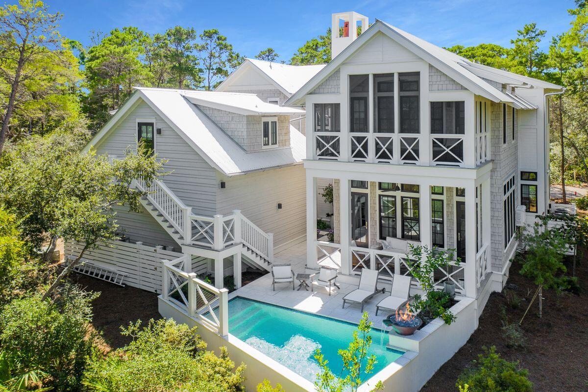 On the western end of iconic Scenic Highway 30A, behind the hand-hewn gates of Draper Lake Coastal Village, a meticulously designed and masterfully curated home is ready for new memories to be built within its walls. Built under the watchful eye of architect Geoff Chick, this 3,521-sq.-ft. home was designed with primary living in mind with a thoughtful floor plan lending itself to three oversized bedrooms in the main home, and a private one-bedroom carriage house providing additional space and privacy to match the needs of a future owner. Architecturally stunning, the blend of Nantucket influence and Pacific Northwest material inspiration has curated one of the most unique offerings in the community, providing a scale rarely seen behind the gates. Upon entry to the home, a grand foyer with mixes of textures and finishing details elicits a reaction of immediate relaxation as well as interest. The open living space blends a chef's kitchen with quartz countertops, custom painted cabinetry and a Thermador appliance package with an open dining area and expansive living areas. The kitchen is further accented by the inclusion of a marble-topped center island as well as an adjacent wet bar with Sub-Zero wine chiller and multi-dimensional ceiling-height tile backsplash. A beamed grid ceiling offers crisp white detailing to the 12-ft. ceilings further accented by pecky cypress planking insets.

The main level of the home also offers transitional spaces into the outdoor living and pool deck, as well as a powder bath, laundry and guest bedroom with en suite.

Moving upstairs, two additional bedrooms flank either side of a grand walkway with rod-iron balusters and a beamed vaulted ceiling above. The master suite on the southern end of the home provides a well-designed walk-in closet, a separate sitting area with Juliet balcony, and a bedroom with vaulted ceiling, private covered balcony, fireplace and oversized en suite bath.

Draper Lake Coastal Village is an escape from the ordinary, perched on the shores of a rare coastal dune lake. It is replete with natural flora, fauna and marine life and is located adjacent to the Gulf of Mexico. Draper Lake Coastal Village also boasts two community pools, boathouses and a 48-ft. Observation tower as well as walking trails that connect throughout its 40 acres.