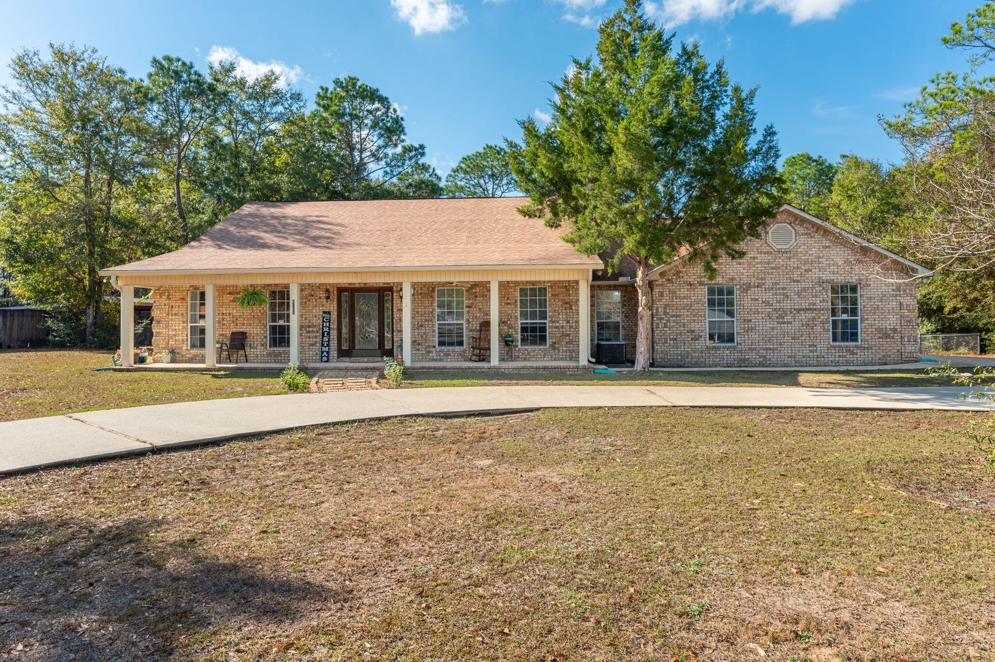 Situated on a generous 1-acre lot in Holly Hills, this well-maintained all-brick home offers both a charming covered front porch and a screened-in back porch. Inside, you'll find 3 bedrooms plus a versatile flex room currently used as an office, along with 2.5 bathrooms. The semi-open layout includes a spacious living room with LVP flooring and a kitchen equipped with stainless steel appliances, solid-surface countertops and an adjoining dining area. The large primary suite features brand-new carpet with thick padding, while the additional bedrooms include new LVP flooring. A portion of the backyard is fenced, though the property extends well beyond the fence line. Completing the home are a 2-car attached garage and an outbuilding in the backyard, offering ample storage options. Buyer to verify all areas of importance.