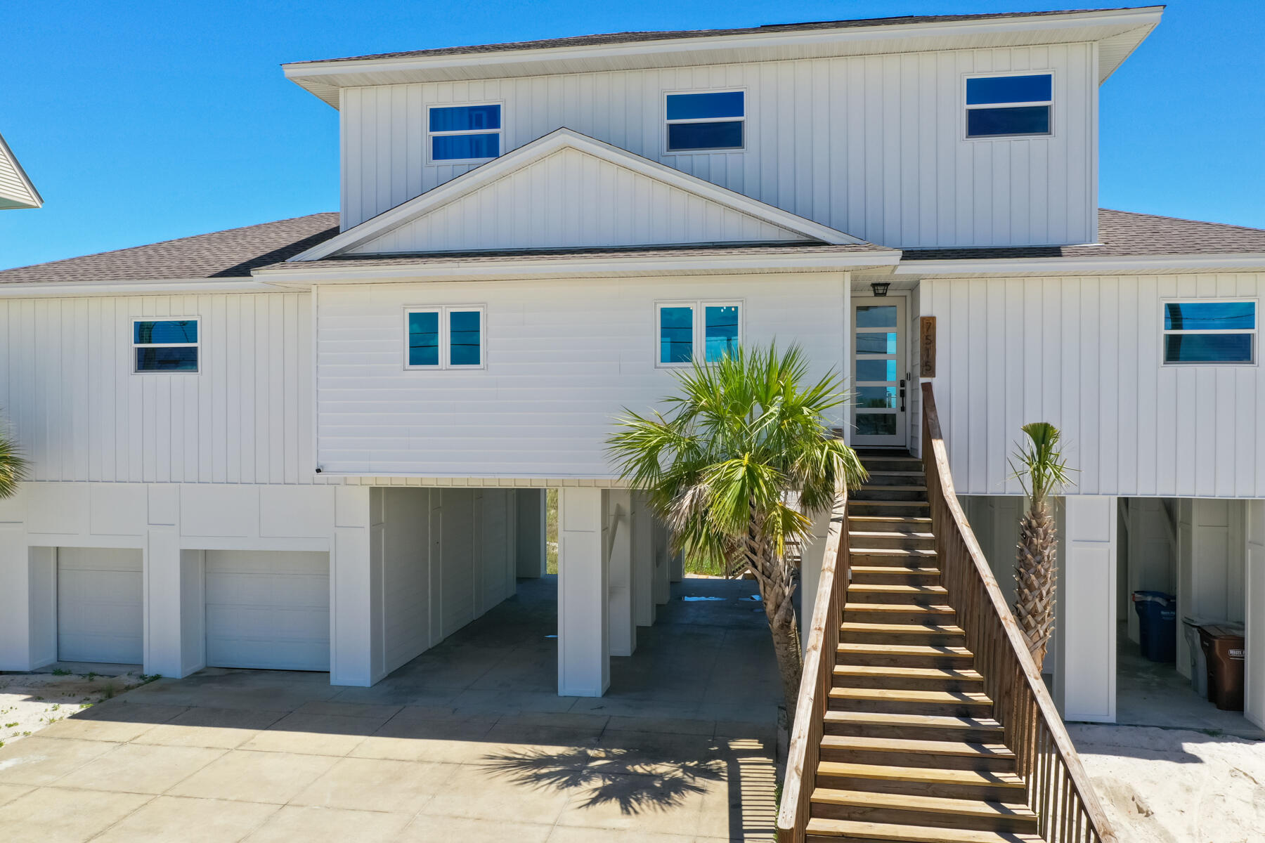 The beach house of your dreams has arrived! Resting about a private sandy bluff along nearly 100ft pristine Gulf frontage, rests this beautiful 4 bedroom, 4 bath, + bunk room, residence lovingly reimagined from top to bottom! The sellers of this home spared no expense in creating a totally immersive experience bringing the best of Florida Gulf front living in, while maximizing comfort and intelligent design creating the best beachfront vacation experience. Navarre Beach has something special unlike other beach towns you may have visited, and this home takes the cake! Every room in the house has incredible views of our dancing emerald green waters and crystal white sands each with their own private bathroom and private sliding door access to a sprawling 1108sf of Gulf front balcony space! Right when you walk in you'll be blown away by the vistas from your coastal modern inspired great room, with the perfect open concept large enough to include the whole family! The kitchen features a gorgeous 5 seat marble island, flanked with matching stainless appliances, bright white custom cabinets with soft-close doors, a lazy-Suzan, pantry, and views of the Gulf and Santa Rosa Sound and ample storage to boot! The dining area hosts 8 persons just off the kitchen and is crowned with shiplap accents that continue throughout this gorgeous home. Natural wood beams draw the eye to the focal point of the living room, a custom build in feature hosting the entertainment center, electric fireplace, natural wood shelving, and storage cabinetry filled with board games for good old fashioned fun! Take a book and relax in the nearby sitting area perfect for those warm summer nights. The unique split floor plan offers maximum privacy in your incredible master suite! An additional custom built in, entertainment center, with fireplace feature highlight this room. A generous en suite with coded storage closet, linen closet, separate shower, additional pocket door closet, and dual marble vanity with glamorous freestanding tub! A precious Polywood furniture sitting area is conveniently located outside every room on the Gulf side to stand the test of time. There's an additional second level bedroom on the west side of home with a Jack-and-Jill style bath, separate laundry/utility closet, and bench seating area at entry to kick off the shoes and relax! The floating stairs open up for an airy light feeling begging you to explore the 3rd floor space! Light abounds as you ascend with viewing windows all around leading you to the precious nautical themed bunk room! Two additional bedrooms each with a private bath and upper level balcony access crown the home. The views are incredible, one can truly see for miles! Want more? How about not one, but TWO enclosed garage spaces to store vehicles, beach toys, and a work shop, with 1100 sf of storage space and it even comes equipped with an electric car charger! There's plenty of room for an RV, boat, additional water toys underneath the home and ample driveway space for oversized vehicles! There's an outdoor shower, and your very own beach walkover to paradise! Make this incredible beach house yours and build memories to last a lifetime!