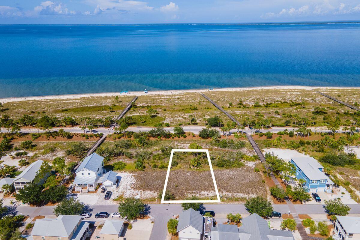 Located in the sought-after Windmark Beach community, this prime lot in phase II offers stunning beach and water views. Situated in Fisherman's Village North, it provides direct access to the Village Center and the pristine, natural beaches of WindMark Beach overlooking St. Joseph Bay. This lot is perfect for building your dream beach home and offers an ideal setting in a vibrant community known for its family-friendly activities. Enjoy fishing, kayaking, biking and the natural beauty that Windmark Beach has to offer. Just steps from the nearest beach access, residents will appreciate the ease of a short walk or golf cart ride to the sandy shores and the community pool. The community features bay front docks, a scenic bike and walking trail, fine dining, specialty shops and a well-equipped fitness center. Create your perfect beach retreat in Windmark Beach, where tranquility and vibrant community life come together seamlessly.