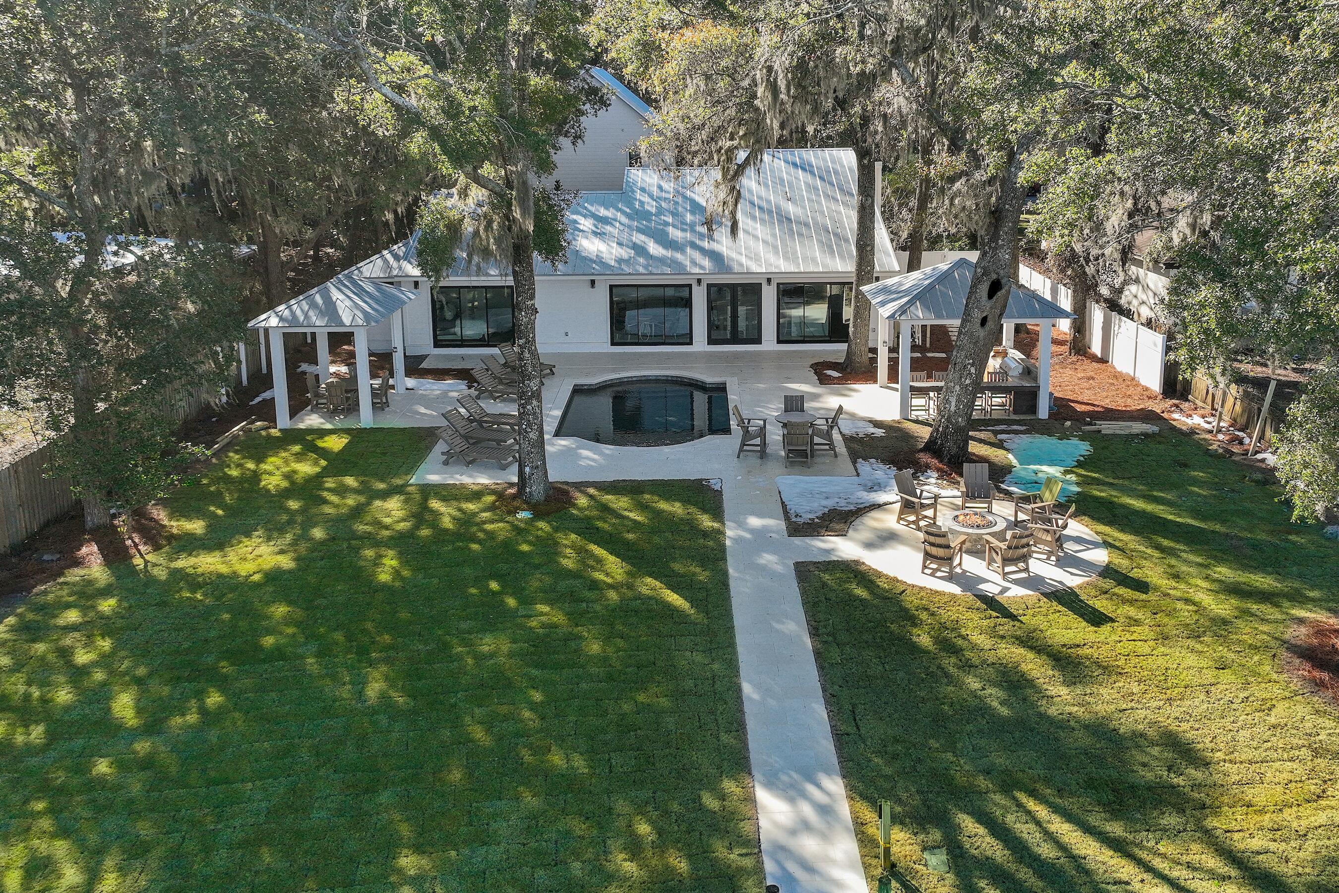 Immerse yourself in coastal elegance with this professionally designed and appointed bay-front estate. Located just minutes from the stunning beaches and sparkling Gulf of Mexico, this home offers a harmonious blend of luxury, comfort, and convenience, all set against the breathtaking backdrop of the bay. This exceptional property offers 6 bedrooms, 5.5 bathrooms, a detached carriage house, a private pool, a two car garage, a private dock and boat lift, providing seamless access to the bay for boating, fishing, or simply taking in the waterfront views. From the custom finishes to the luxurious outdoor amenities, every detail has been carefully curated to create a true masterpiece. The main residence boasts an open-concept design with expansive living spaces perfect for entertaining. Each space exudes style and comfort.  Floating vanities in this home add to the modern, luxurious feel of the bathrooms. The gourmet kitchen is both functional and beautifulperfect for culinary creations and entertaining. A detached carriage house adds versatility, whether for guests or as a private retreat. 
Step outside to a private oasis, featuring a sparkling pool, outdoor kitchen, firepit, and a charming cabanaperfect for hosting  gatherings or enjoying a tranquil sunset. 
This is more than a home; it's a lifestyle. Schedule your private tour today and make this exceptional property your waterfront dream come true.