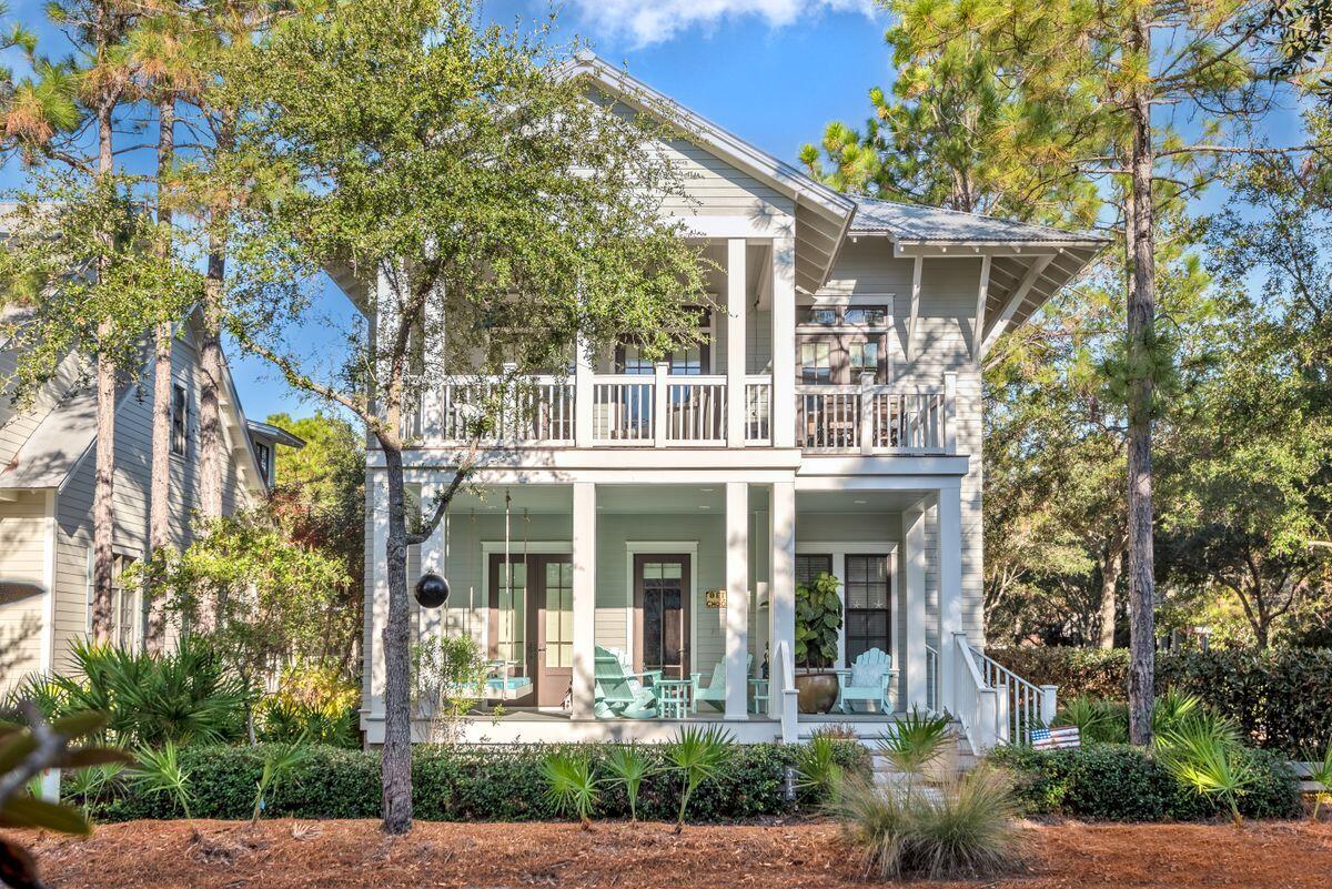 This beautiful beach house with its covered porches is enviably located on a corner lot in WaterColor.  The white cottage-style kitchen is fully loaded with quality appliances including a farm sink and Viking range with hood. Granite counters flow into a breakfast bar seating four. Imagine entertaining in this generous open space with vaulted ceiling providing an abundance of airy natural light. This upper floor enjoys excellent views through multiple sets of French doors and from the wrap-around screened balcony. It's the perfect place to chill out on loungers with a drink and look down on the world passing leisurely by. End each perfect day in the master bedroom with its spa-like marble bathroom including twin vanities and jetted tub. The lot includes a desirable self-contained carriage house for guests above a two-car garage. Hop on the golf cart and attend a picnic with family and friends in Wood Fern Park or stroll to the neighborhood pool at Camp WaterColor with its cafe and Lazy River. With shops and amenities just outside the gates, this could be your peaceful little chunk of private paradise.