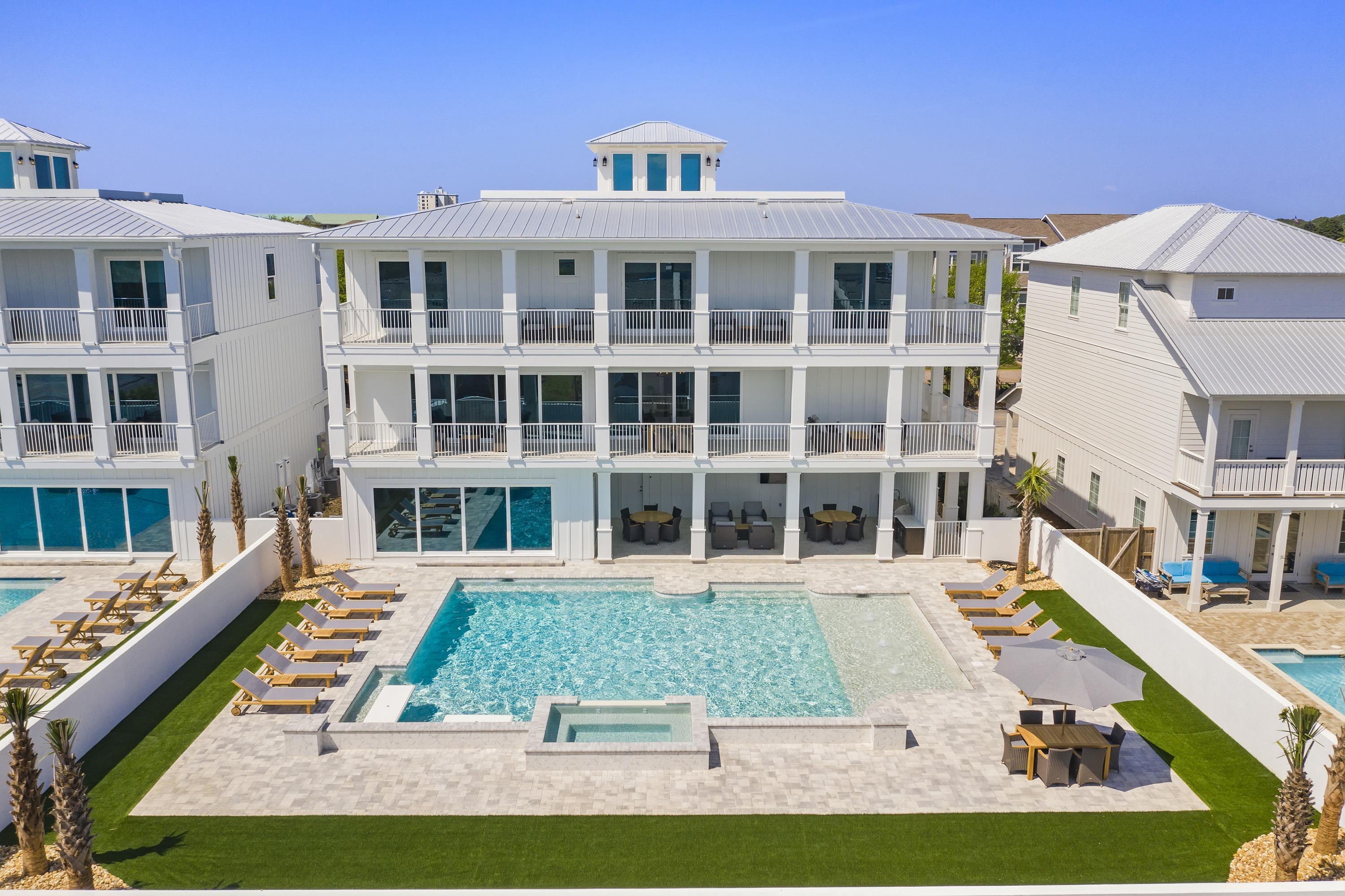 Introducing ''Hypnautic,'' a newly constructed 6,333-square-foot 8-bedroom designer showpiece with stunning coastal interiors, state-of-the-art amenities, and a resort-style pool. This luxury beach home is already a significant income producer with $265K in projected annual rental income. No mandatory HOA dues. Open-air comforts include a custom-designed LED-lit pool with sundeck, elevated spa, summer kitchen, covered outdoor dining, four terraces, and rooftop deck, offering sensational sunset vistas. Lifelike synthetic turf provides zero maintenance and year-round beautification. This home has all the essentials for entertaining:  ample parking, large gathering spaces, seamless indoor-outdoor flow, and a lavish chef's kitchen - plus a private movie theatre and fully equipped game room A sparkling white exterior with metal clad roof echo the home's fresh approach to modern coastal design. Clean lines and crisp whites are sophisticated, classic, and calming. The kitchen is supplied with top-of-the-line appliances including a 6-burner Wolf range and under-counter wine fridge. The extra-large kitchen island with seating for eight is highly functional and on-trend. Bedrooms include private baths with designer finishes. "Hypnautic" is just a short walk or bike ride to the pristine beaches of the Emerald Coast, eateries, and shops. Stylish furnishings convey in sale. The adjoining home 204 Driftwood Rd is also for sale.