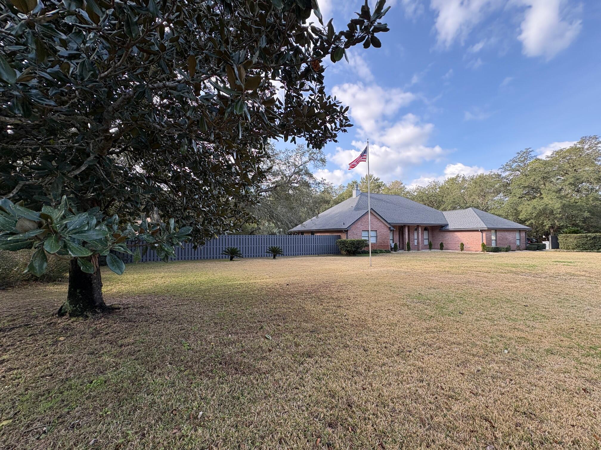 This newly renovated, pristine, 3/2/2 sits on almost an acre of incredible, nature-embraced privacy. Enjoy breathtaking views down the entire 12th fairway of Hidden Creek Estates Golf Course and full views of the 13th hole from the comfort of your front porch rocking chairs.This all-brick Hidden Creek home built on a premium lot backs up to the crystal clear Hidden Creek. Gorgeous Live Oak trees and mature landscaping offer a park-like setting in your fenced backyard. Steps from your open-concept living space, a large screened Lanai overlooks plenty of green grass for that new pool you might be dreaming of. New double-side privacy fence and a large shed for plenty of storage. Extra-large side entry garage with thoughtfully extended concrete driveway for easy in/out. Open floor plan includes spacious, newly-renovated kitchen and breakfast nook. Gorgeous Upton Brown Natural Wood cabinets, stunning Patagonia Granite counters and backsplash, all new stainless steel counter depth appliances including built-in drawer microwave. 2-way fireplace in an open vaulted ceiling family room look out through multiple glass double doors. With a stately tray ceiling, a deep jet tub, and 2 walk-in closets in the sunroom-like Primary, the views of your spectacular Live Oak tree are sure to relax.  Both updated bathrooms include Cultured marble sinks, tubs, and showers. Enjoy the oversized windows throughout every room for a true inside/outside Floridian feel. Only tile and new hardwood flooring throughout- no carpet.  Popcorn removed from all ceilings and entire house freshly painted. New roof and gutters. New water heater. Full access to all HOLLY BY THE SEA RECREATION FACILITIES with indoor/outdoor pools, fitness room, pickle ball courts, tennis courts, basketball courts, walking trail, pavilion, fishing/viewing pier, boat launch and more! Join Hidden Creek Golf Club or just pay to play.   Come see what could be yours!