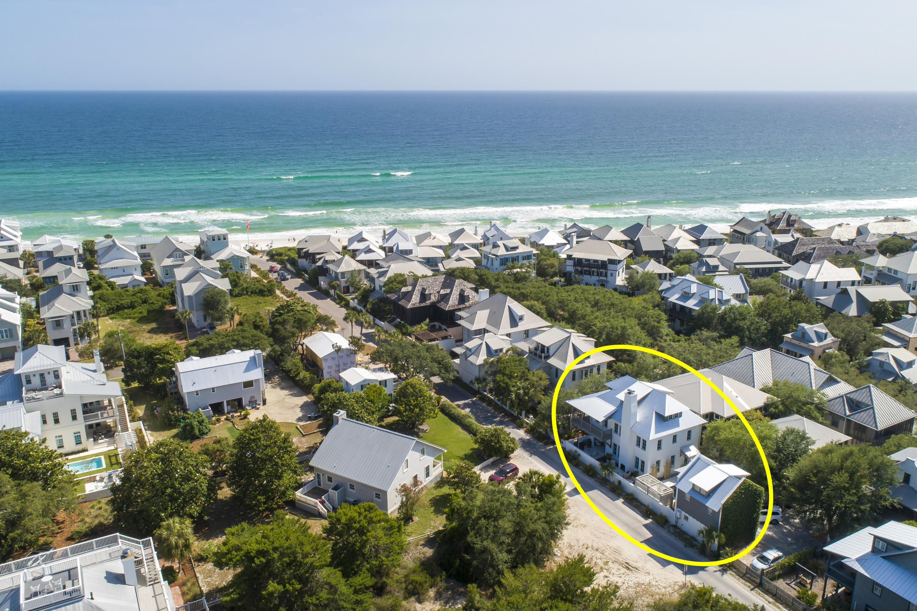 Look no further for a stylish retreat in a quiet corner of Rosemary Beach. This stunning 3-story, 6-bedroom, 6-bath home comes fully furnished and is well-appointed in luxurious finishes with styling by noted designer Ashley Gilbreath. Located in the southeast quadrant of Rosemary Beach, this rare find is perfectly positioned as a chic escape just steps from the Gulf of Mexico, Coquina pool, the children's playground, and, of course, the lively shops and dining of Rosemary Beach.
The aesthetic is both sophisticated and approachable with a coastal air that calms and relaxes. Every room flows with a cohesive style while the layout creates defined spaces with purpose and interest. Finishes incorporate a mix of natural elements and high-end upgrades selected for both style and function. 

First Floor

Upon entering the home, notice the open floor plan with dining, kitchen, and living areas connected to make an expansive family-friendly space. Exposed beams, durable concrete paver flooring, and outstanding decor combine to create a relaxed and inviting atmosphere.

The family room boasts an oversized sofa in custom upholstery, comfortable club chairs, and a well-placed entertainment area. Mixed metal finishes and varying textures enrich the upscale, yet relaxed feeling.

In the kitchen, an impressive Wolf range complements marble countertops, a mother of pearl backsplash, and a beautiful oversized island with custom cabinetry and brass hardware. Hidden outlets and a crisp seafoam tone elevate the island further. On the opposing wall, elongated custom cabinetry and marble counters house a wet bar with pellet ice and a bar sink, extensive kitchen storage and floating wood shelves for an added organic element. Statement light fixtures hang above the island while the upgraded SubZero refrigerator is paneled for a seamless look. 
A 10-seat dining set with cozy bamboo chairs and an elegant glass top await family dinners or dinner parties. 

A hidden door between the dining room and kitchen gives way to a first floor bedroom/study, which also connects to a full downstairs bath. Note the shower upgrades with floor to ceiling tile and transom over the door. The bath then connects to a courtyard entryway and drop zone for toys or beach gear.

Second Floor

Three bedrooms on the second floor are outfitted in tranquil beachy undertones with each containing its own in-suite bath. The master bedroom boasts a private balcony and wrap-around porch. Vaulted ceilings and beautiful views add to the ambiance. Note the custom window treatments, custom upholstered bed, and plush linens. The master closet features built-in shelves with custom hanging and storage solutions. The master bath features floor to ceiling marble tile in the oversized, double walk-in shower with an extra long vanity, separate toilet room, and an additional owners' closet for convenience. 

A full-size laundry room on the second floor brings efficiency and added storage with a convenient location between the bedrooms.

Both guest bedrooms have their own bathrooms and are appointed in serene tones and textures to evoke the feeling of a quiet coastal retreat. Professional styling here combines natural elements and water tones for the perfect organic-meets-upscale aesthetic. One room features a custom canopy bed with hanging linens, custom roman shades, rattan details, and a happy mint tone while the other features a custom upholstered bed, plush linens, and a bold twine light fixture. 

Third Floor

From an iron staircase to the third floor, discover a smart space designed for families. An open landing for playtime or screen time comes with oversized cushions and a wide screen TV. Third-floor owners closets allow for easy restocking. A full bathroom with classic floor to ceiling subway tile and penny-round floor tile make for a fresh kid-friendly wash room. Rustic sliding shutter doors add a vintage touch.

Adorable cabana-striped awnings make a grand entrance to each of the two bunk rooms. Each bunk room has two double bunks, for a total of 8 beds. Custom draperies allow the bunk rooms to be closed for staggered wake and sleep times. Additional toy storage and play areas can be found in cleverly concealed nooks inside the bunk rooms. 

Outdoors

A studio carriage house serves as an additional haven with a full-size kitchen, Smeg fridge, floating shelves for added storage, sleeper sofa, king bed with custom upholstered headboard, charming furnishings, elegant wood floors, vaulted ceilings, and two car garage below. An expansive courtyard between the main house and carriage house adds to this home's thoughtful footprint with multiple outdoor living and dining areas. Highlights include a privacy wall, chic pavers throughout, a custom double cabana, refreshing heated saltwater pool, and casual outdoor dining area. Continuing around the corner is a wood-burning fireplace faced by a sunny outdoor lounge area and further, a separate covered lounge area complete with TV, dining set, and summer kitchen with a natural gas grill. 

For the family on the go, find a personal bike rack, private access to Winston Lane to the east, and wooden boardwalks and sidewalks for biking through Rosemary Beach. 

Additional upgrades to note:new roof, heated private saltwater pool, tinted turtle glass windows throughout the main house, new irrigation system, tankless gas hot water heaters for both the main house and guest house, and new HVAC for the main house.