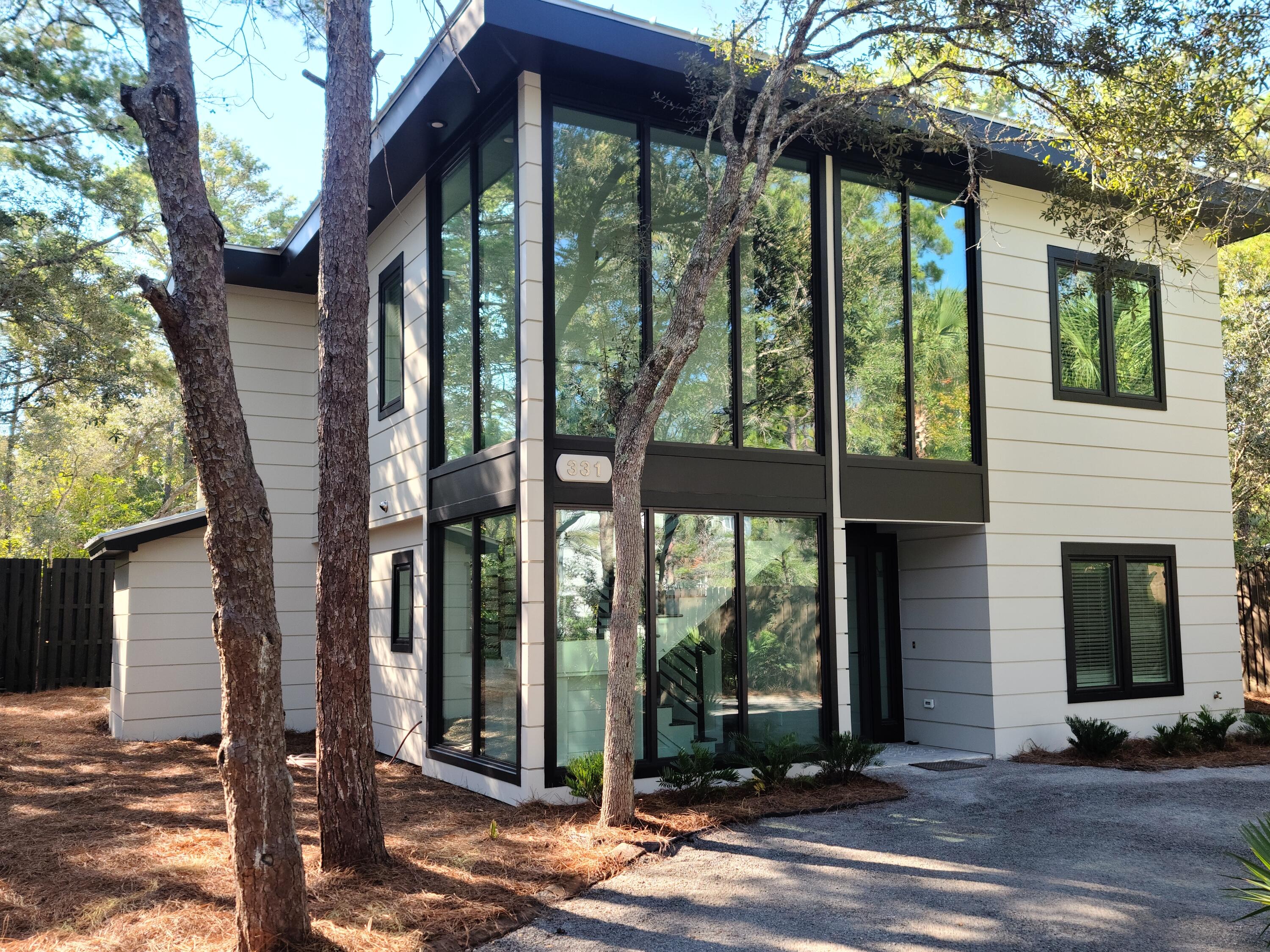 Experience  contemporary construction on one of the most pristine, private lots in Old Seagrove. From the street, this home makes a modern statement—two stories of expansive glass sheets rise, creating unobstructed views of natural wonders as light floods the entryway. This custom-plan provides wonderful interior living with two master suites—each with a beautiful master bath. Both floors offer full living areas. The downstairs living walks out to a backyard sanctuary, with a heated, saline pool & spa as well as a covered patio with gas hearth. Impeccably manicured, the outdoor landscape provides maximal privacy. The home is set back off Canal Street while also embracing a sizeable backyard den for poolside relaxation. One of the sellers is a FL. Lic. Real Estate Agent The property includes a circular drive with abundant parking as well as a weatherproofed, covered port for a golf cart. All of this, with convenient access to Seaside and a number of public beach accesses through a network of some of the most naturally beautiful streets on all of 30A.

All measurements and information is deemed reliable but should be verified by the Buyer.